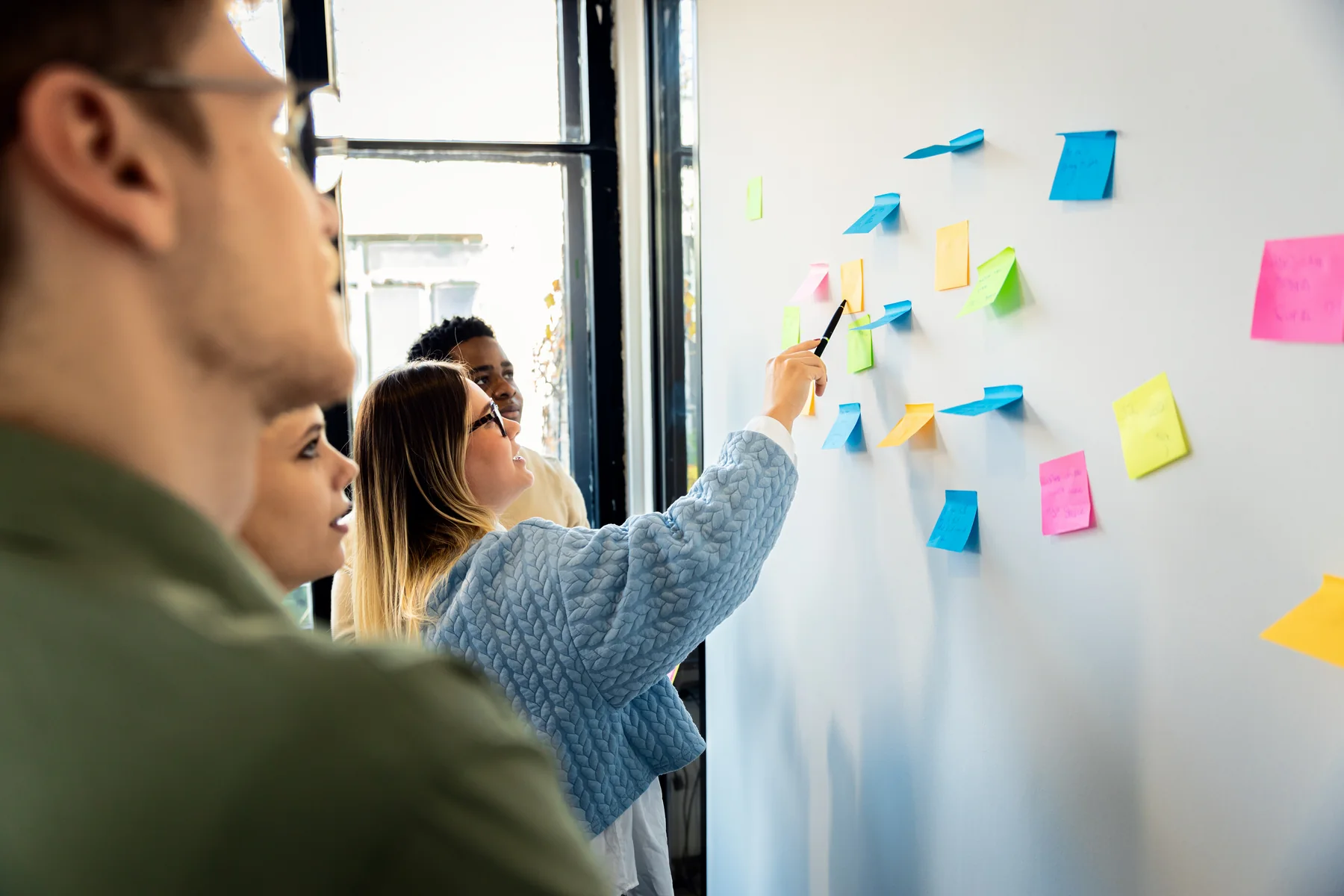 Team Brainstorming Together with Colorful Notes Indoors