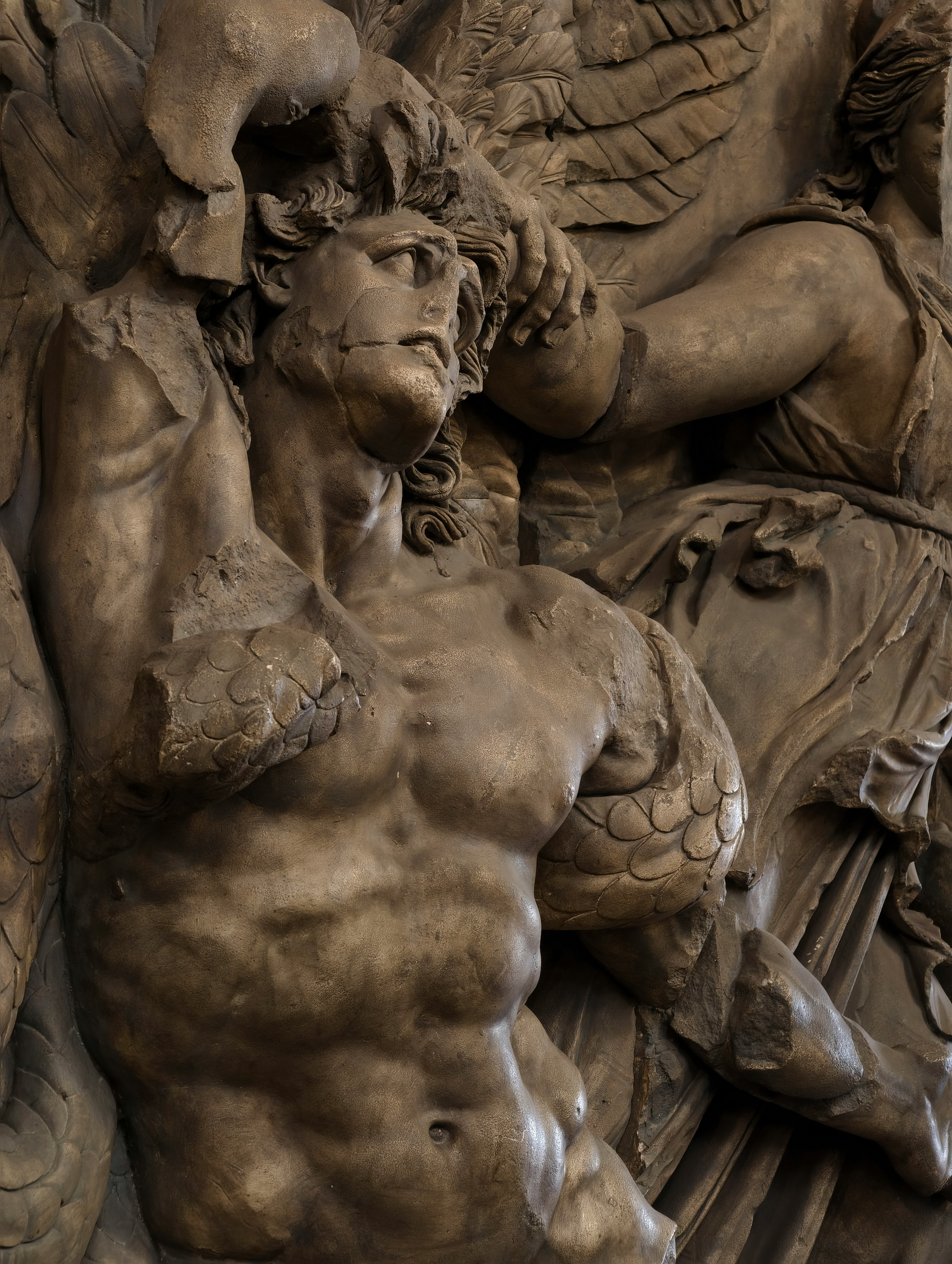 Marble sculpture of a muscular man with broken arms