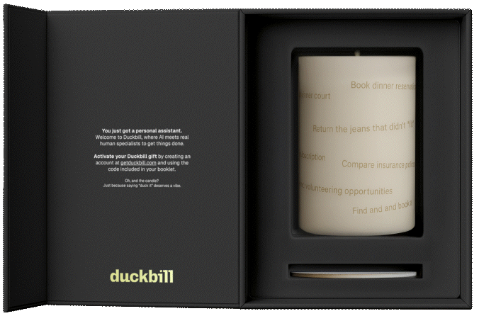 An open Duckbill gift box containing a candle with text printed on it, alongside a message describing Duckbill as a personal assistant service. The candle features tasks like "Book dinner reservations" and "Return the jeans that didn't fit."