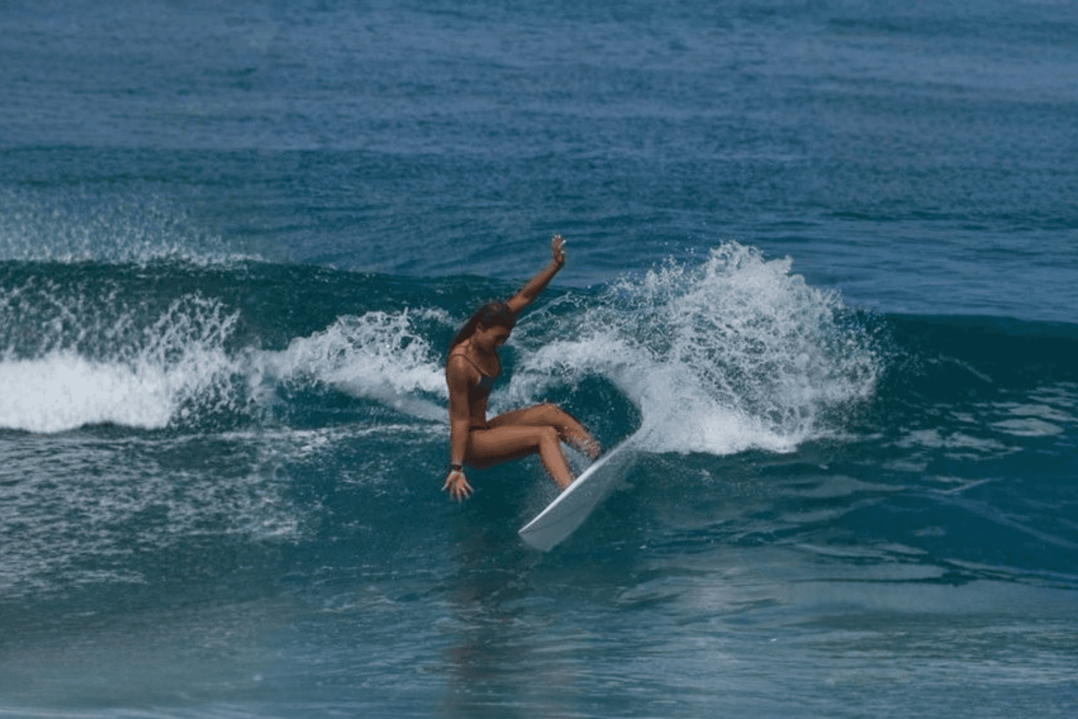 Woman in a dark golf outfit mid-swing on a lush green golf course, with sand bunkers and trees in the background, promoting a 38% discount.