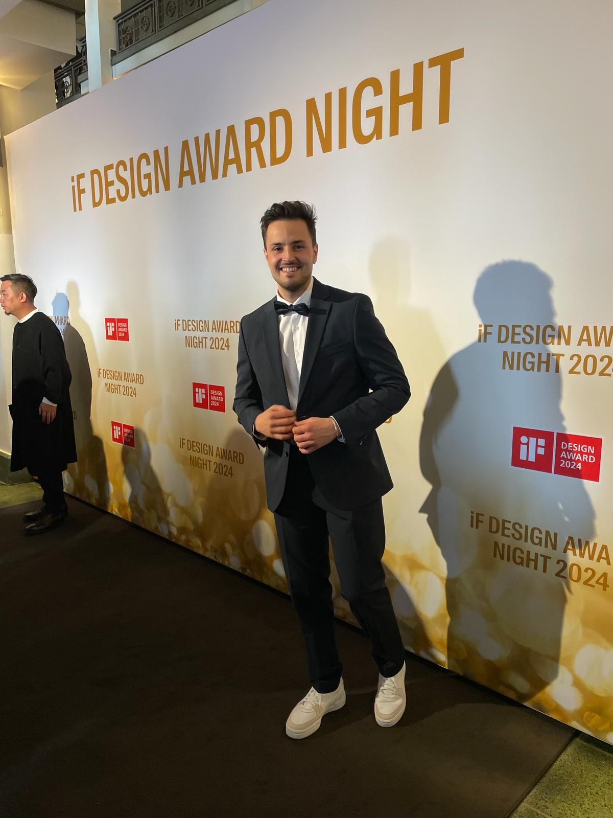 Man in suit standing in front of iF DESIGN AWARD NIGHT backdrop.