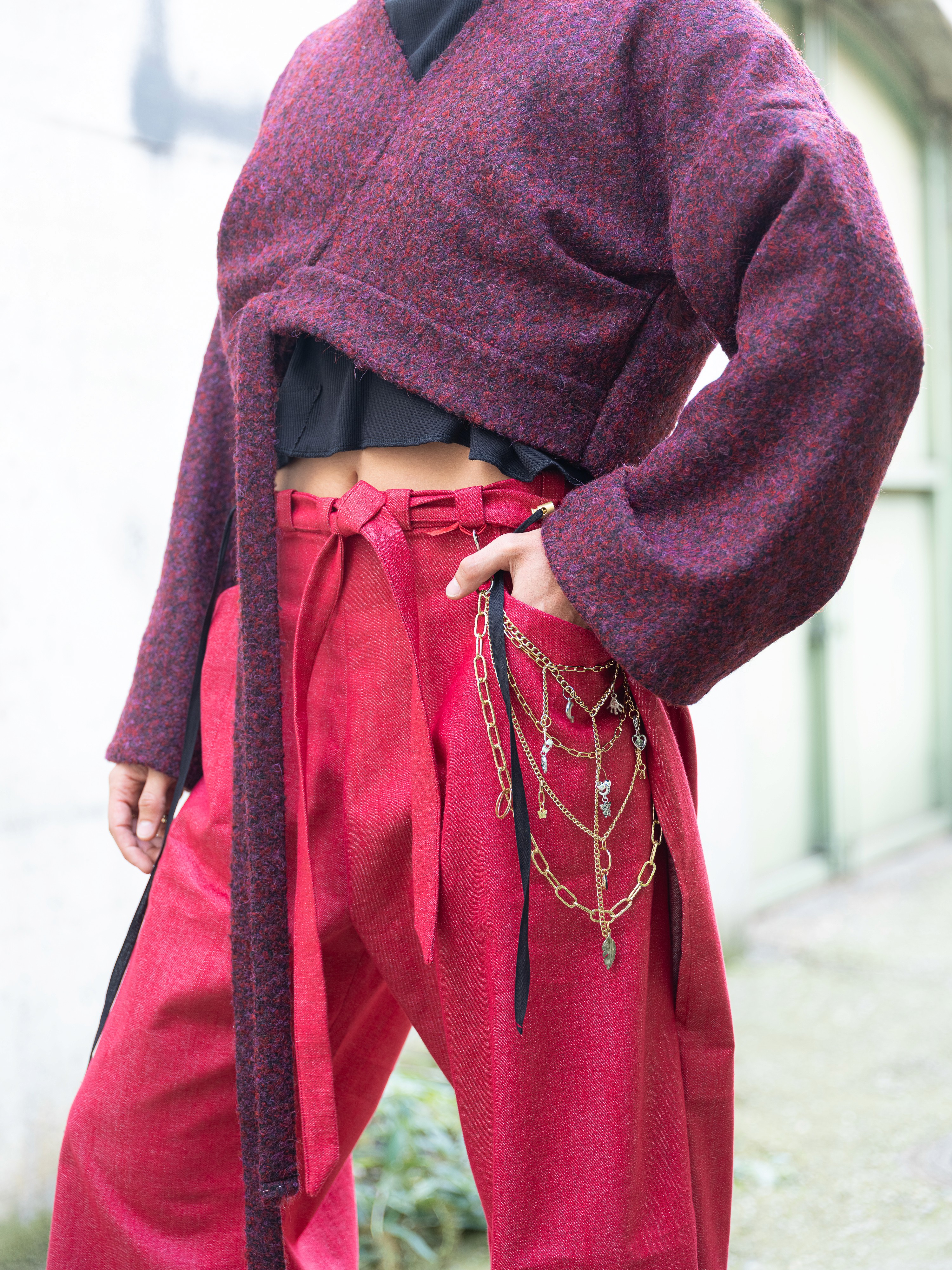 close up of purple jacket and redtrousers on a model