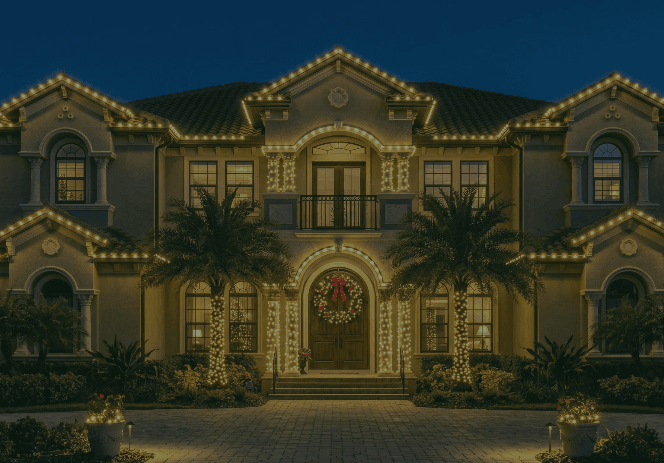 Tampa home at dusk with warm white C9 Christmas lights tracing the roofline and palm trees wrapped in lights