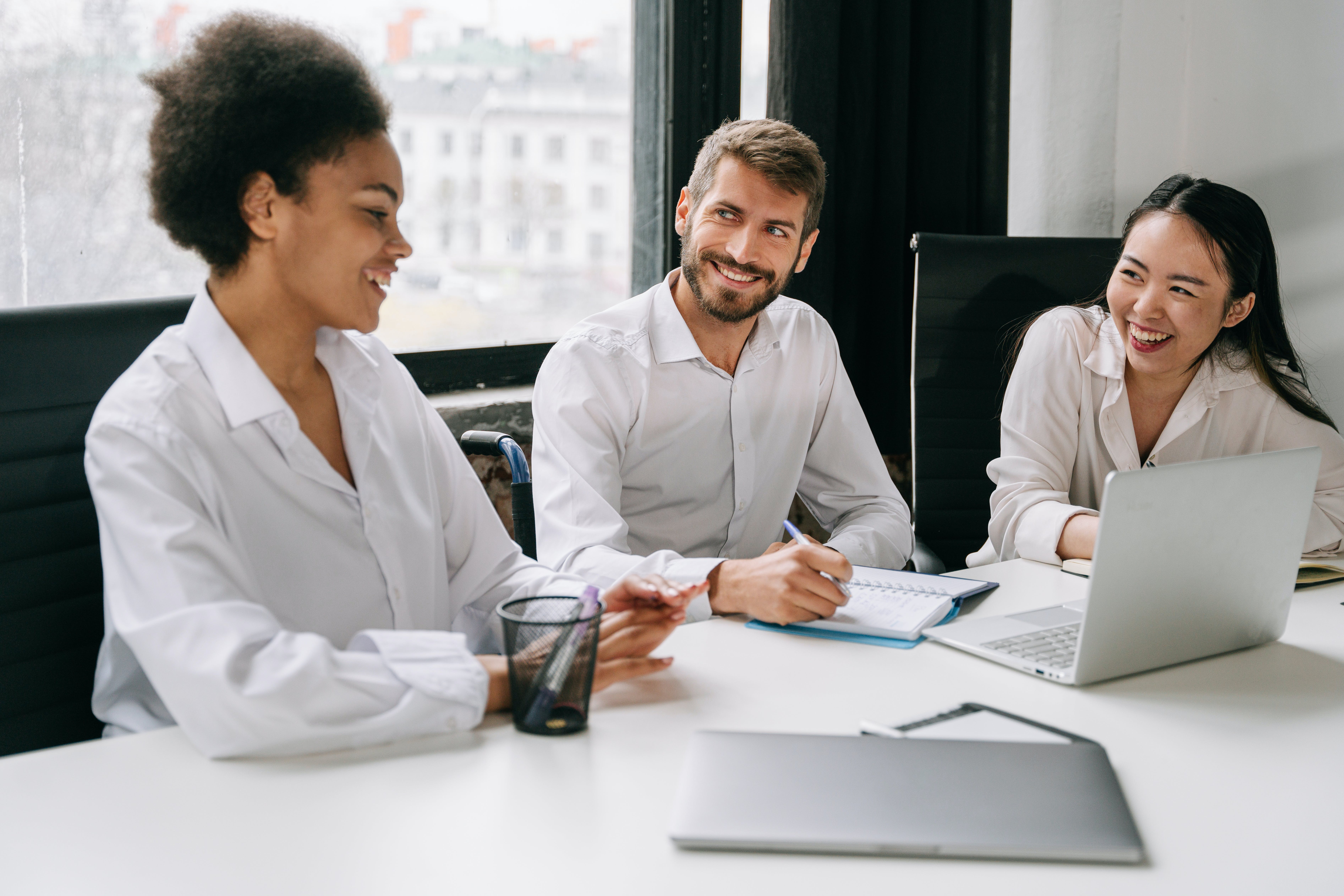 Three people smiling after they found the best mortgage broker