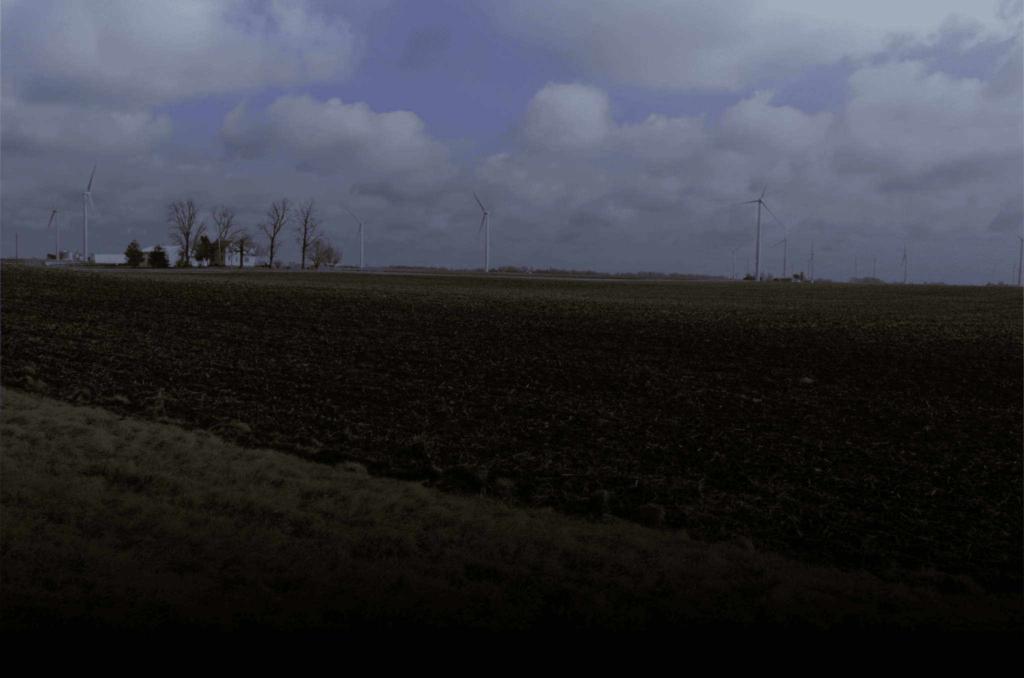 a smiling man sitting on a couch in a living room