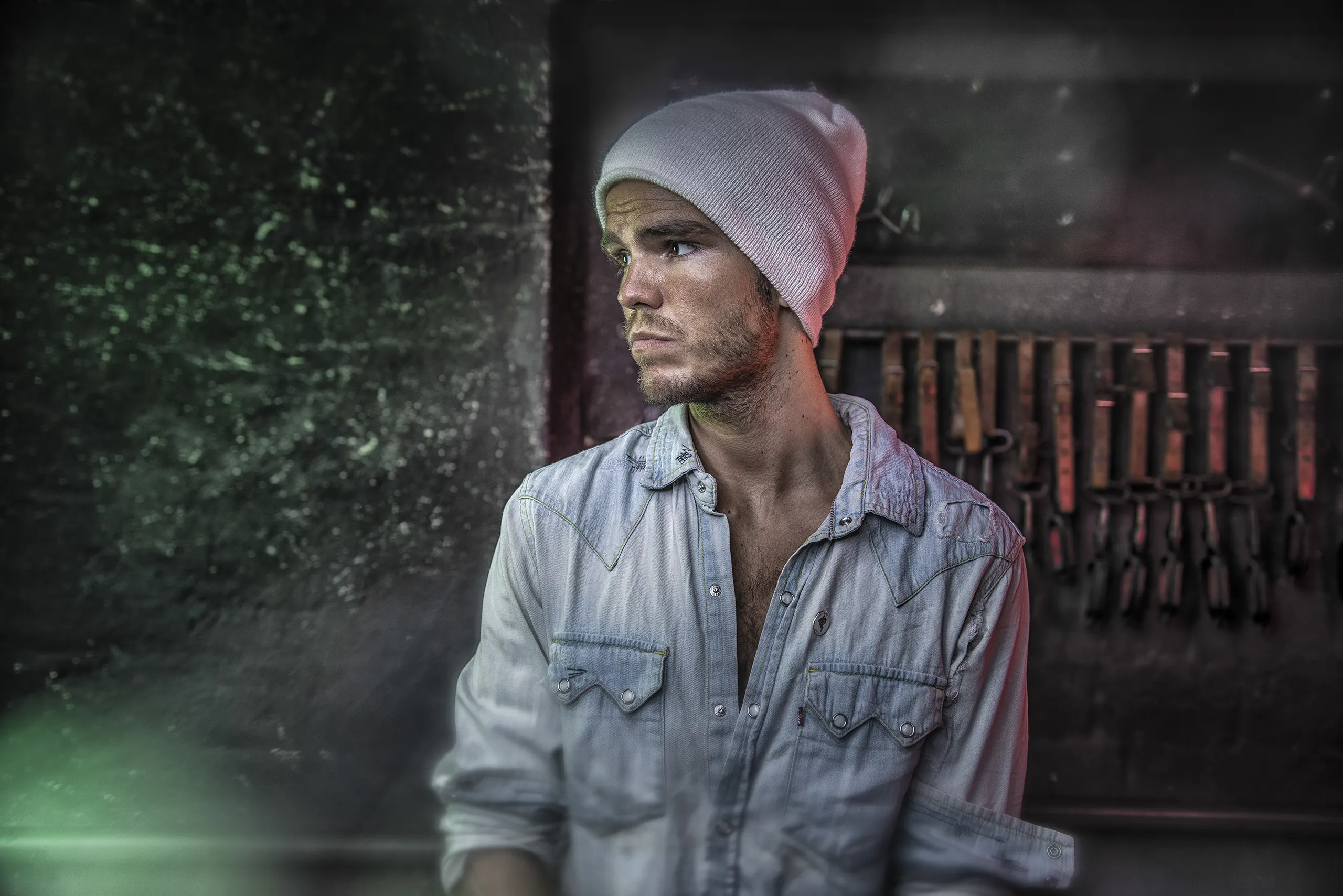 Atmospheric shot of a member of the band Kaleo in a gritty backstage setting.