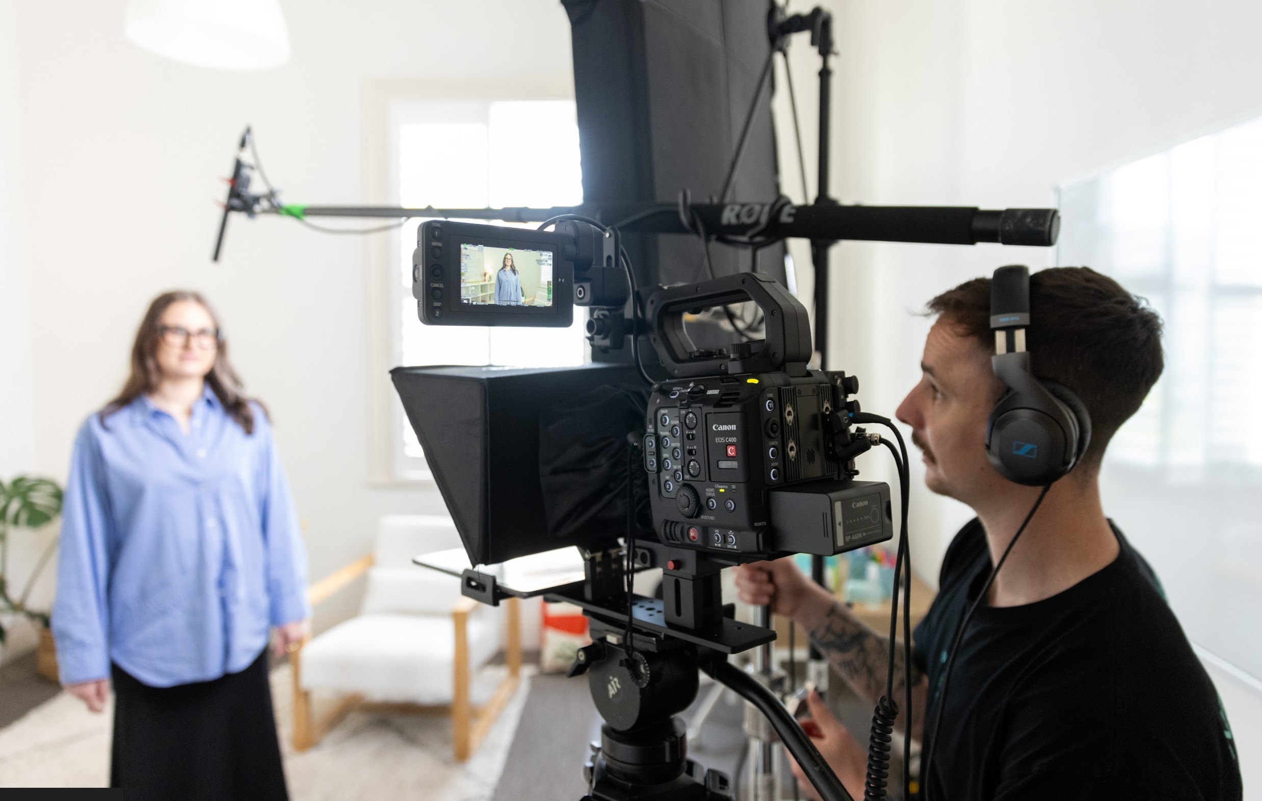 Corporate videographer from Neon Sheep Films filming an on-camera interview in a Melbourne office