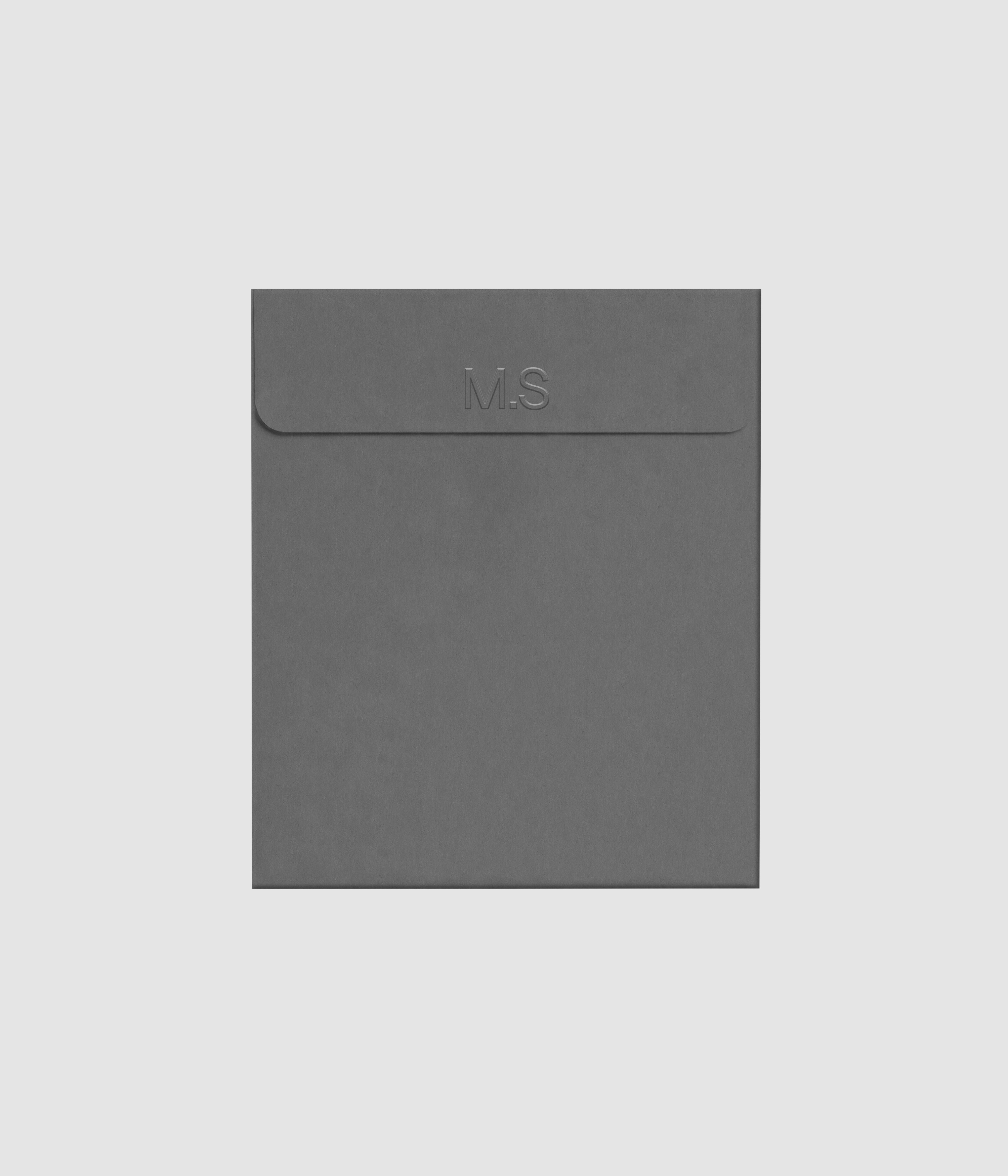 Gray envelope mockup featuring embossed letterpress logo effect on Mockups Supply