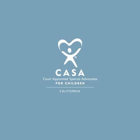 A white robot with a glowing red eye stands in a field of yellow flowers at sunset.