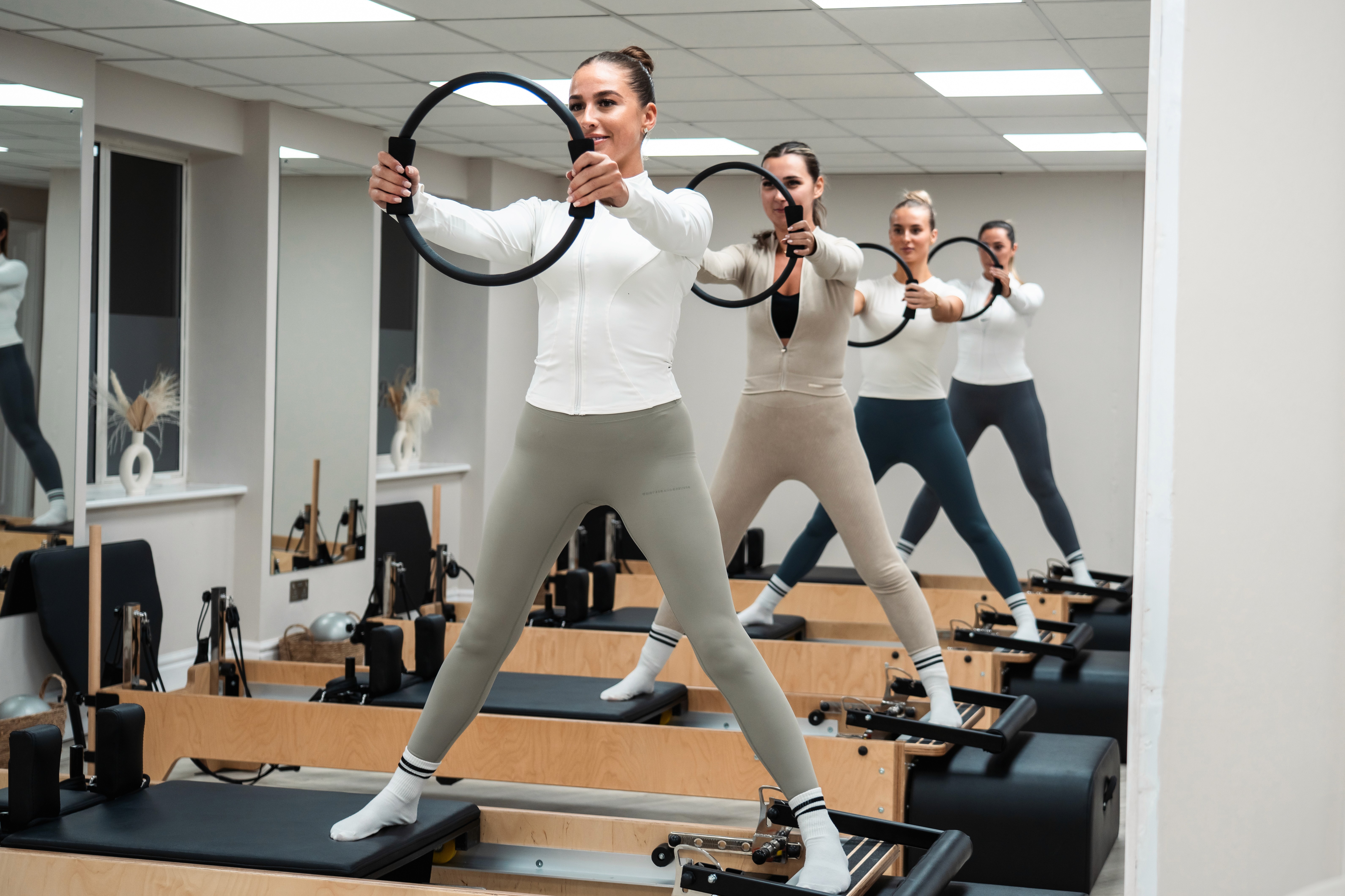 A snapshot of a Rise and Reform reformer Pilates class.