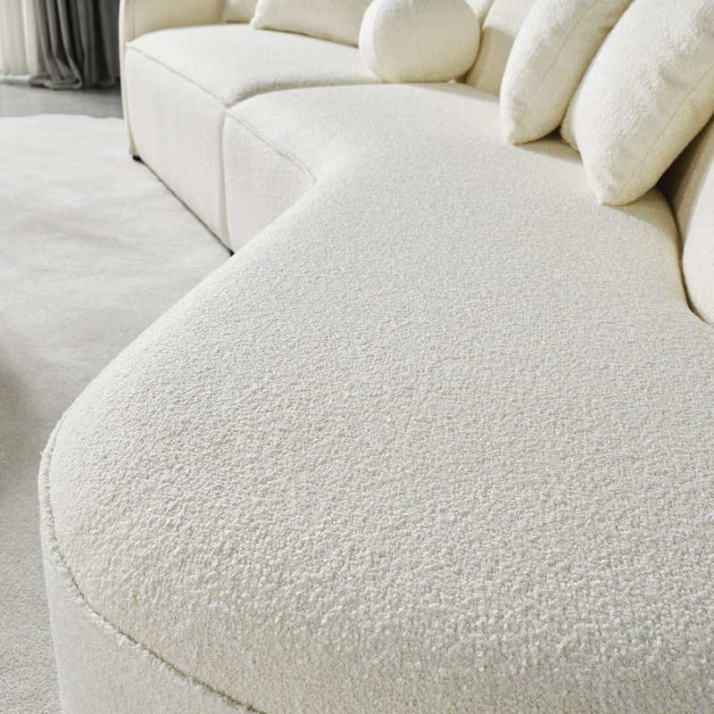 Elegant Japandi sofa with a soft boucle finish and modern curves, ideal for creating a cozy and sophisticated atmosphere.