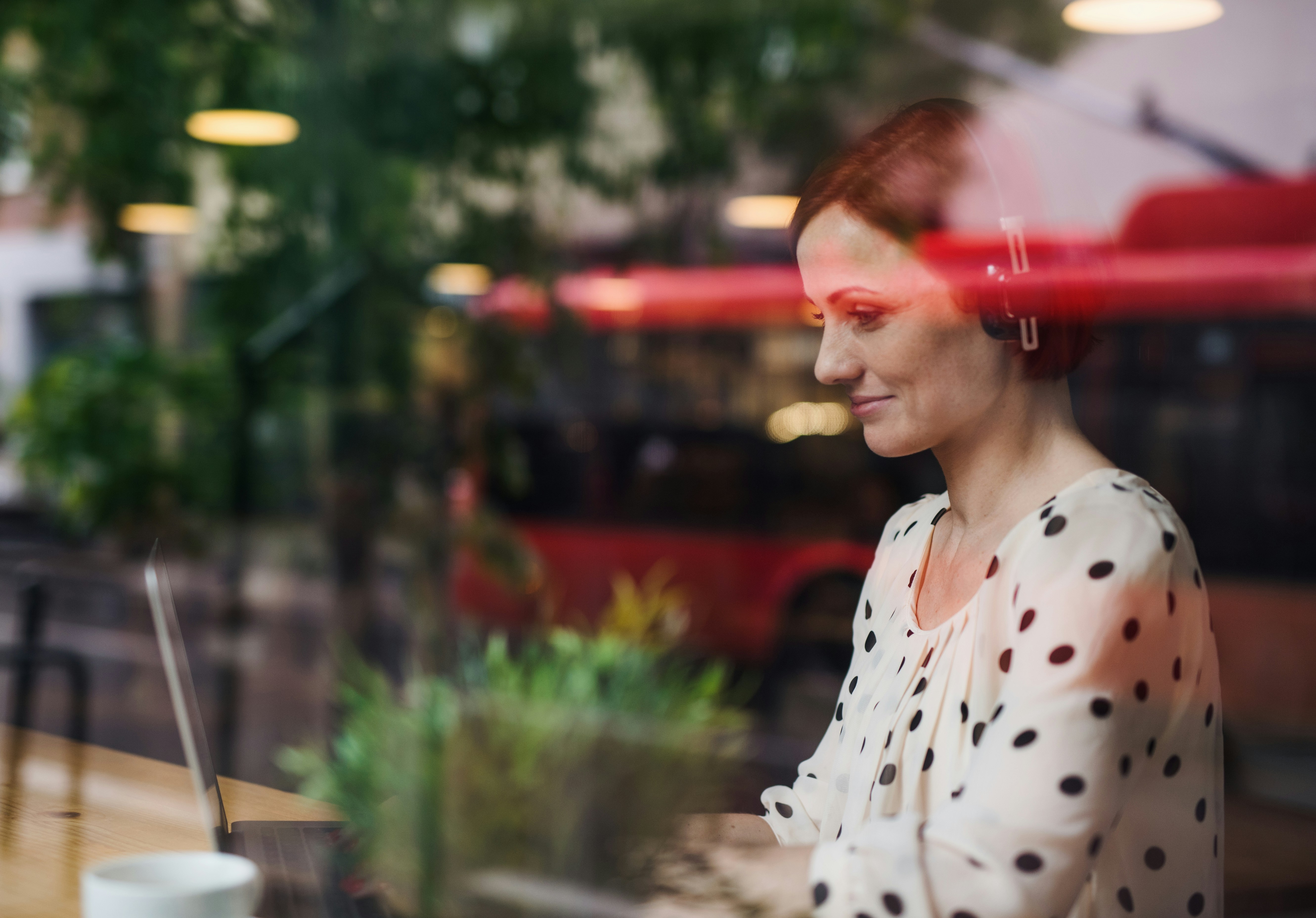 woman sitting around table holding tablet