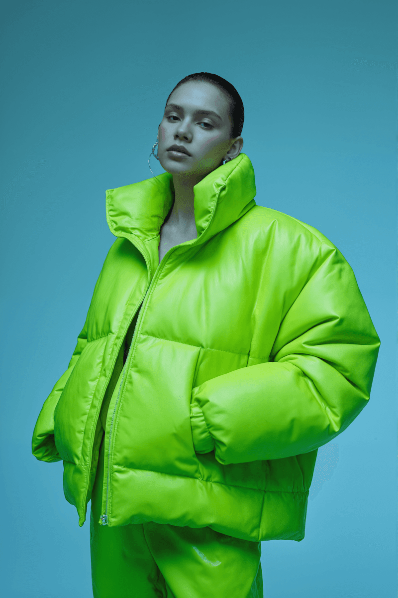 AI generated high-end fashion close-up of a bright neon green puffer jacket.