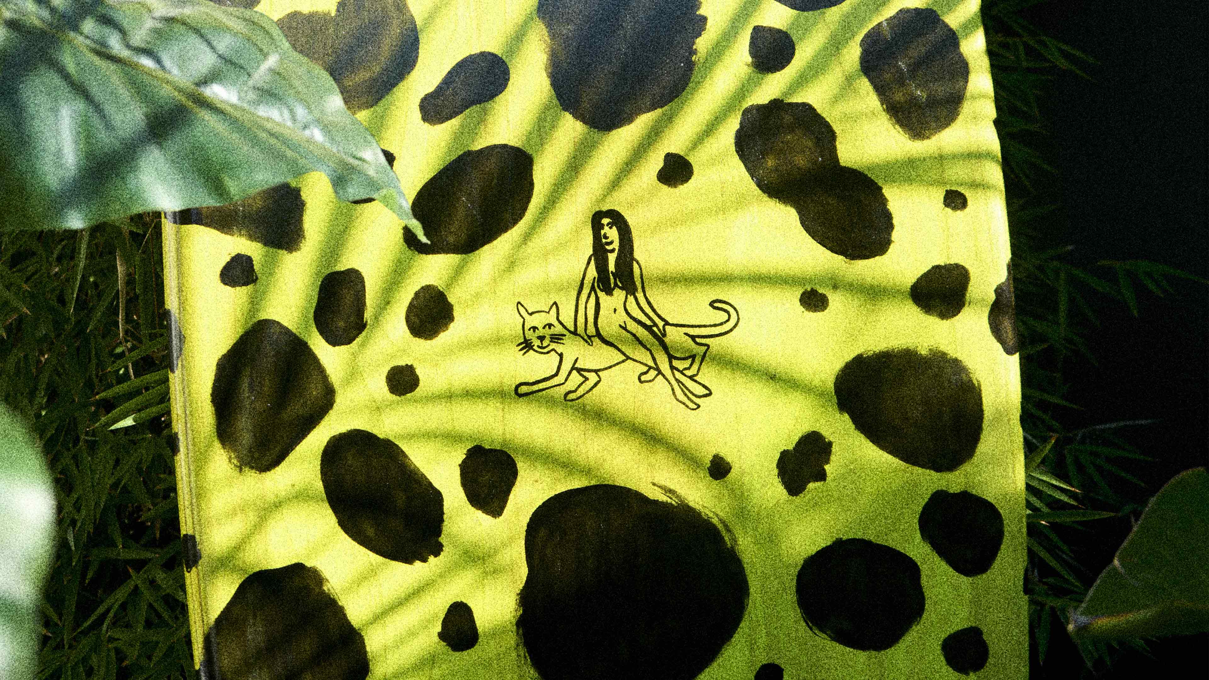 A wooden surfboard with painted leopard spots