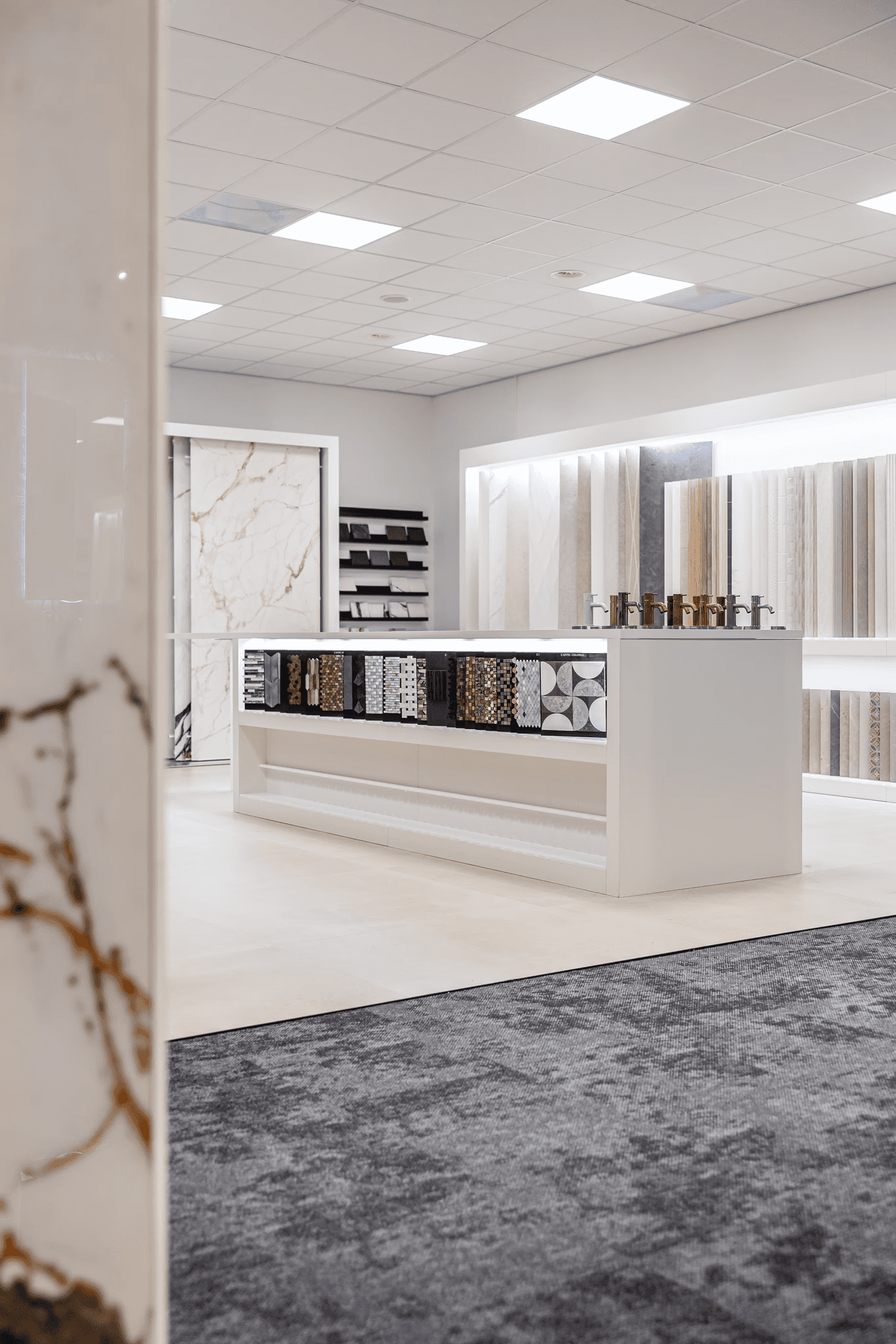 Smiling man and woman standing together in front of a framed abstract artwork.