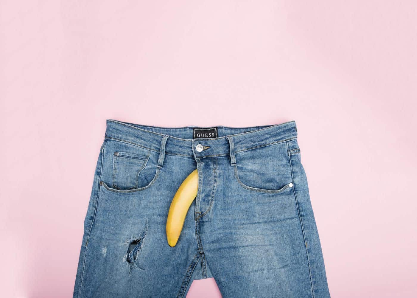 Best erectile dysfunction apps - Banana and denim jeans on a pink background