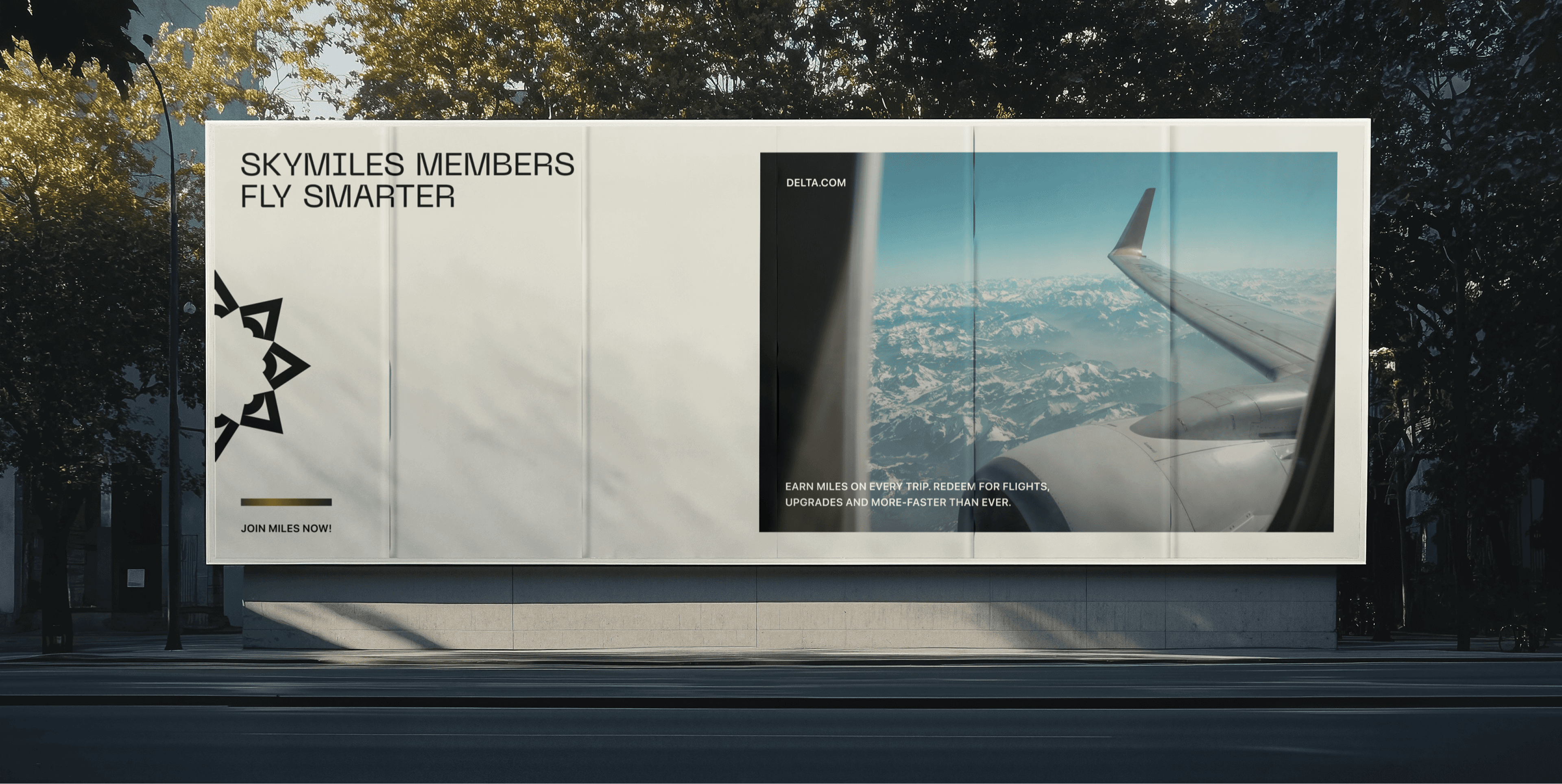 A large billboard displays an advertisement with imagery of an airplane wing slicing through a clear blue sky above snow-capped mountains, promoting a frequent flyer program with the text "SkyMiles Members Fly Smarter."