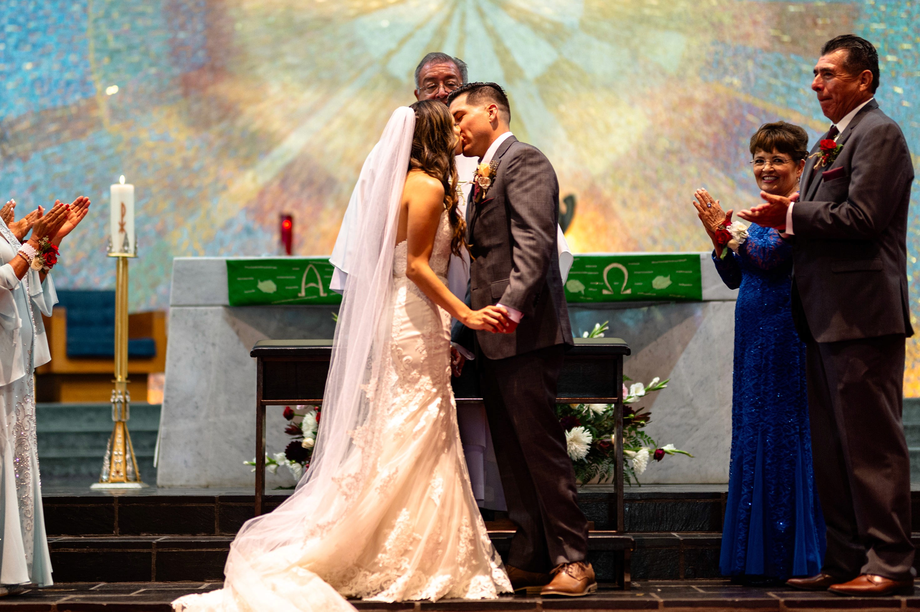 First kiss at Sacred Heart Church wedding ceremony