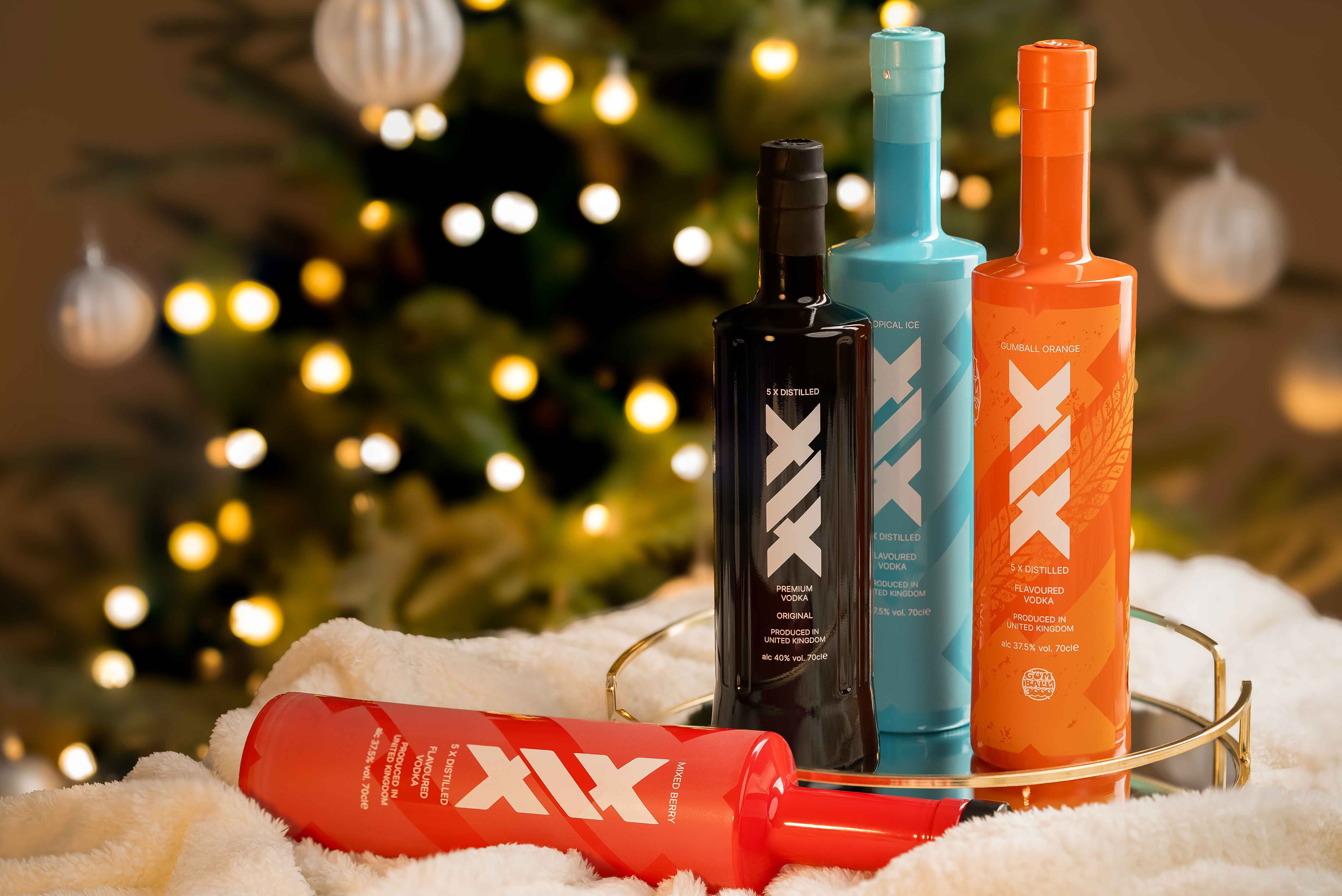 man standing in front of a red car wearing a red suit