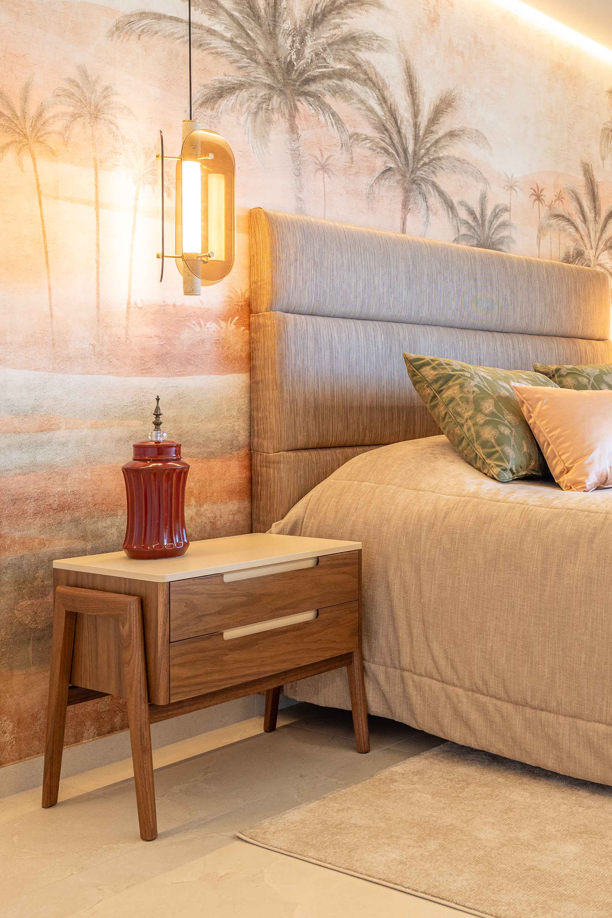 Bedroom with a painted palm mural, a woven headboard and a brass pendant light