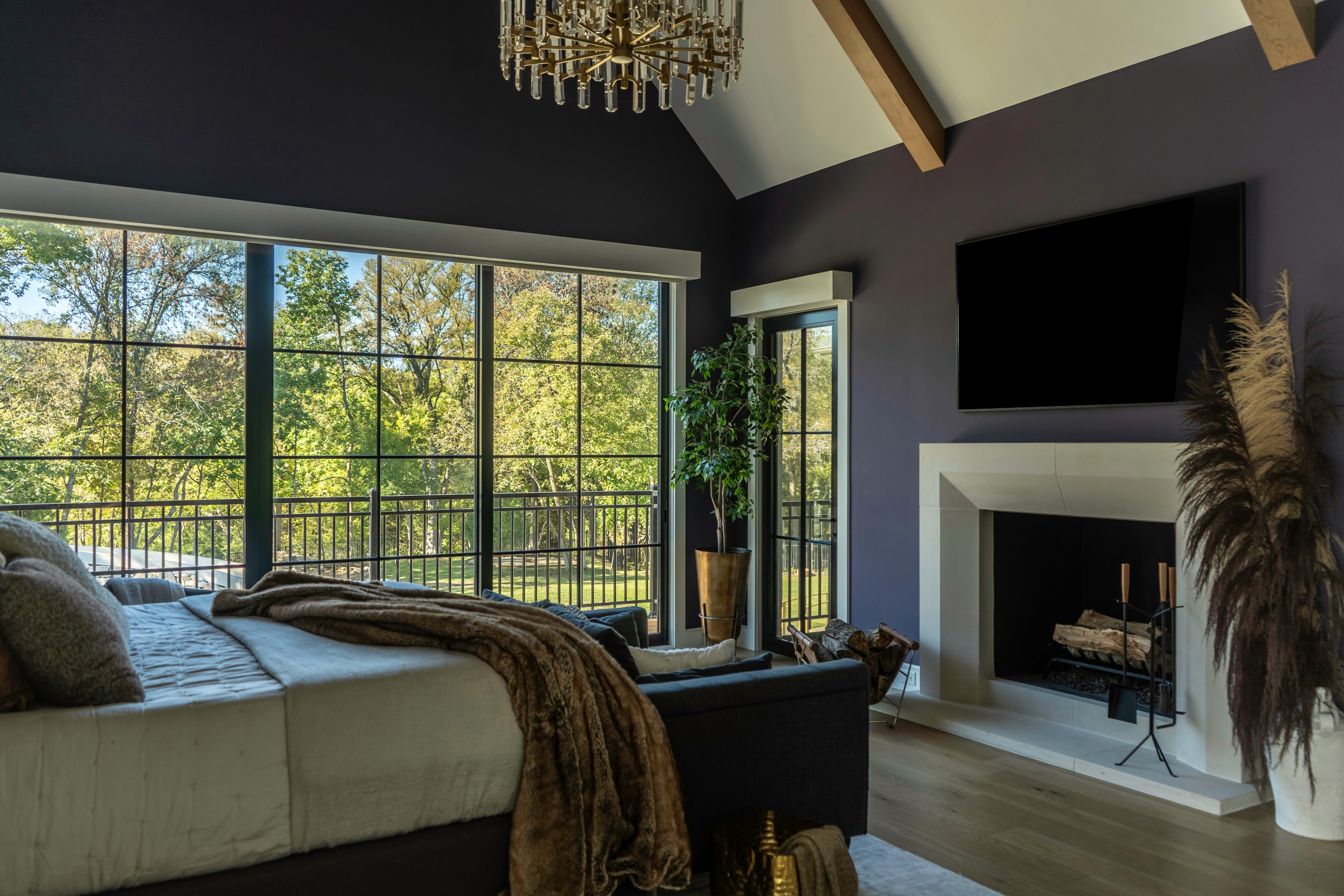 Luxurious primary bathroom with copper freestanding tub, crystal chandelier, and hexagonal tile backsplash