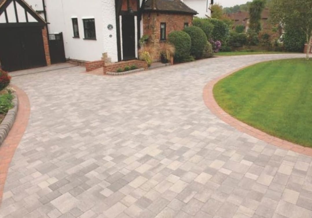 a black and white photo of a man moving a rug