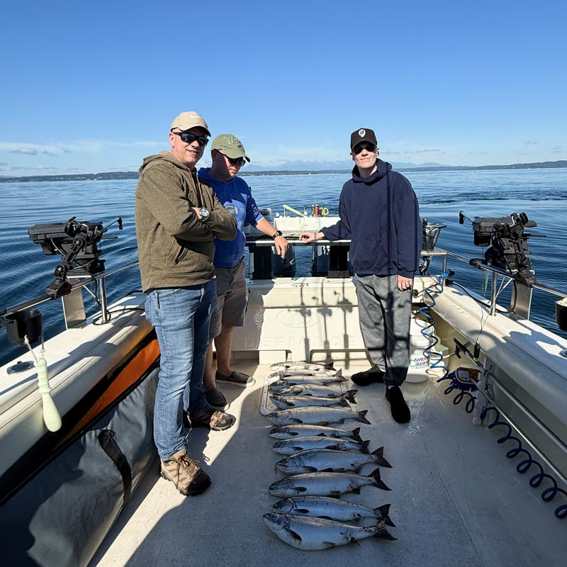 Crew on a deck of a boat with salmon layed out 