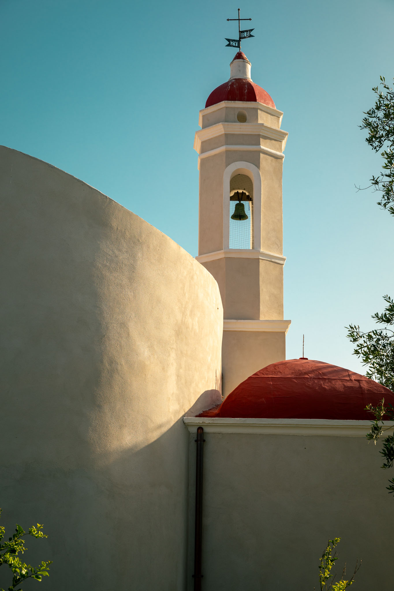 A person with short blonde hair holds a vintage camera.