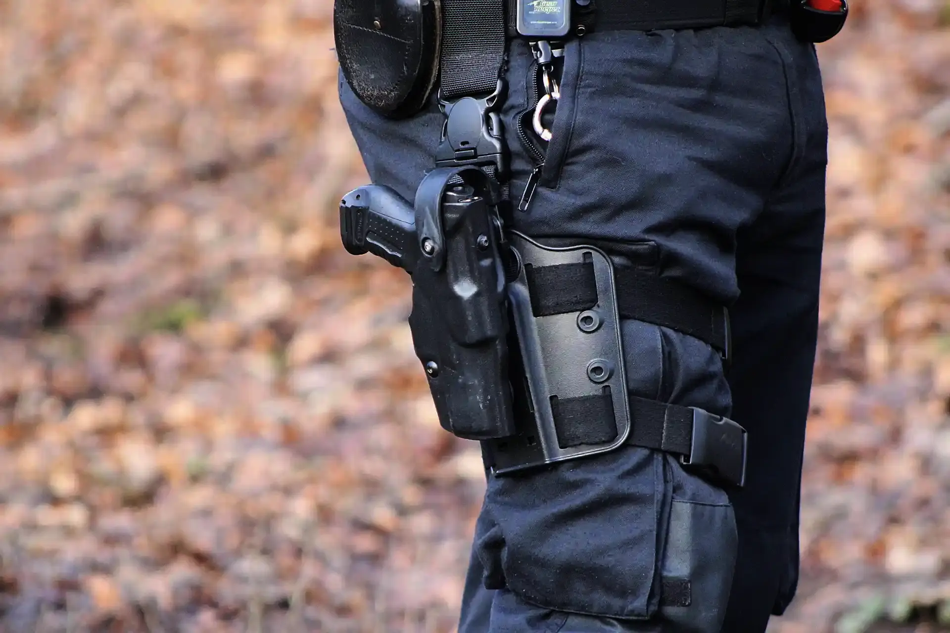 Armed security officer with tactical gear and holstered firearm
