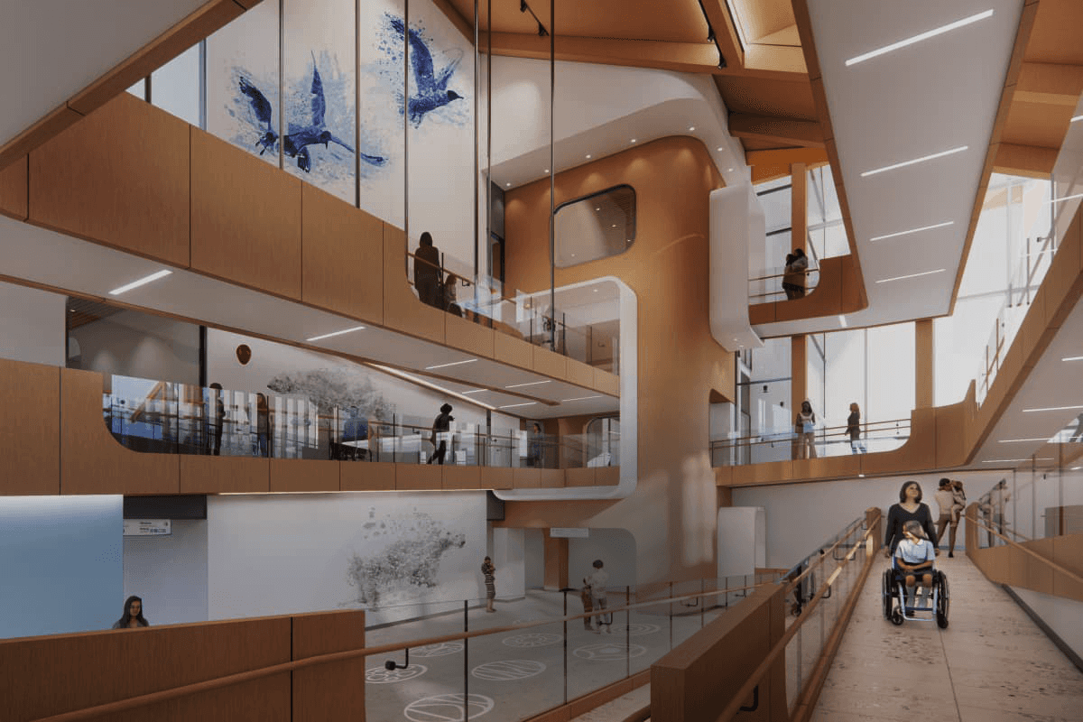 Rendering of a pediatric hospital atrium featuring a multi-story ramp and integrated care model designed to support children with complex needs and their families.