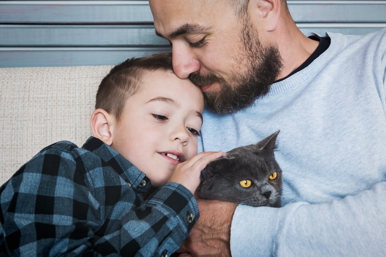 father and son with cat