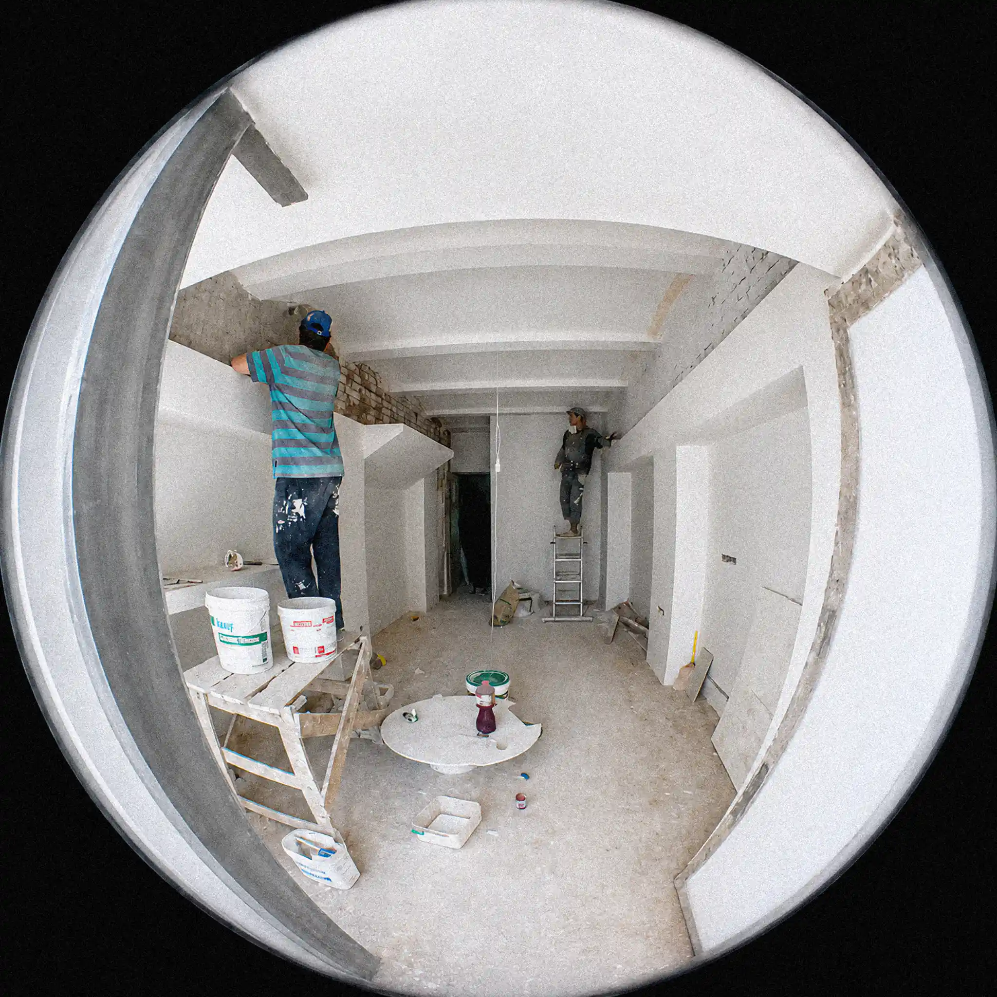 "A construction-stage photo from Twinkle coffee shop on Sumska Street in Kharkiv. The circular fisheye effect came from shooting through a door peephole, not from a camera lens."