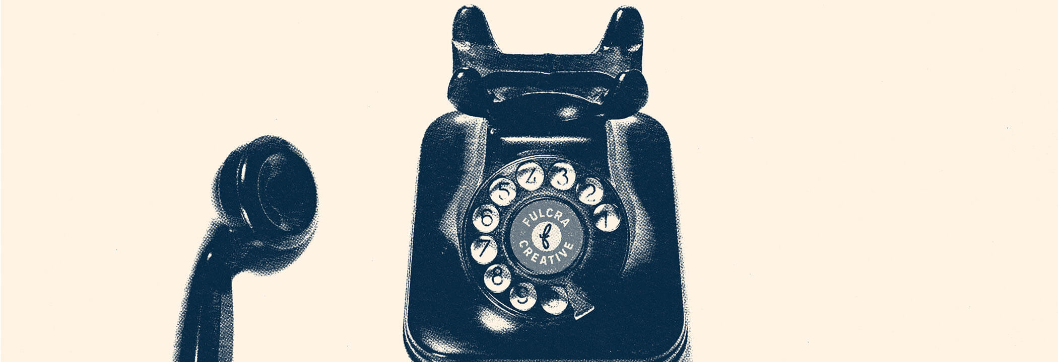 1950s style telephone with the Fulcra Creative logo on the turn dial