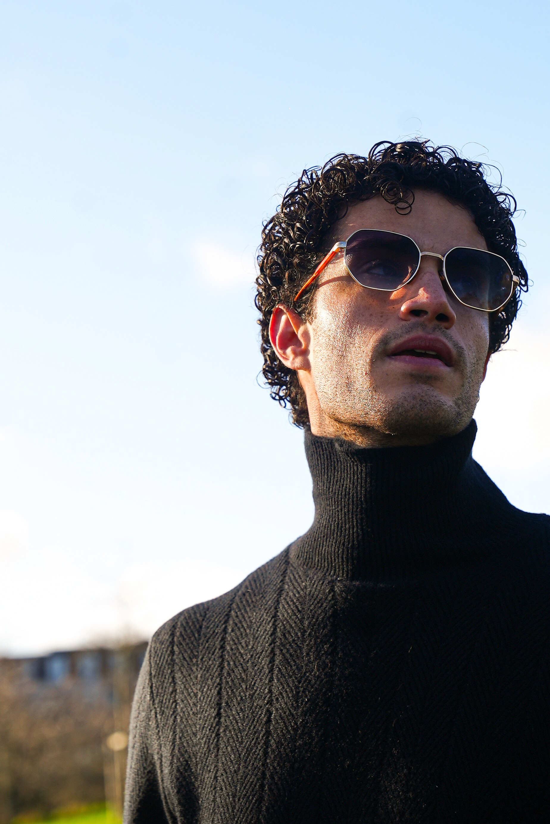 Woman hugging Shiba Inu dog in front of white fence