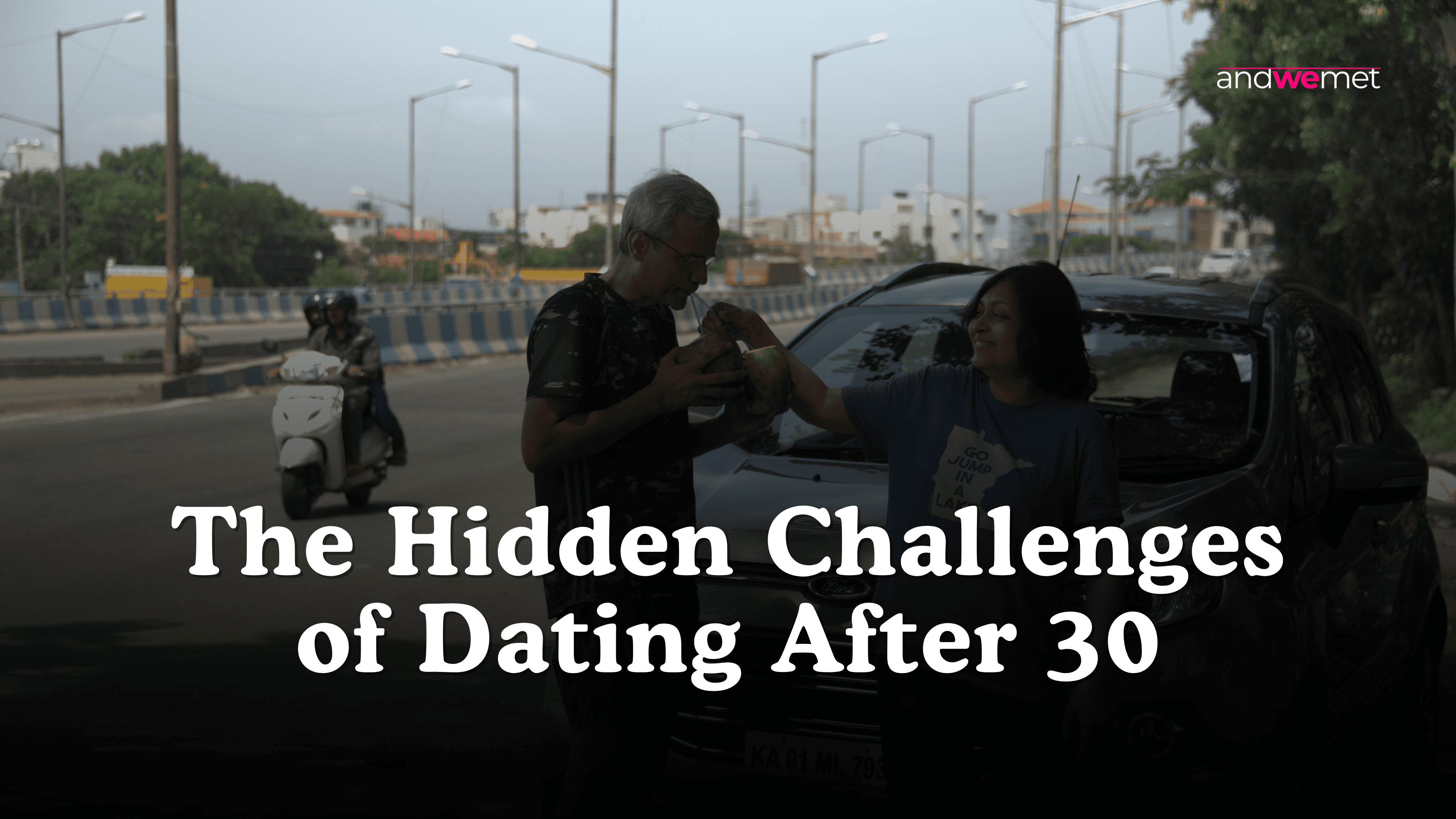 Indian couple sharing a coconut water together on a busy street representing everyday connection while dating after 30