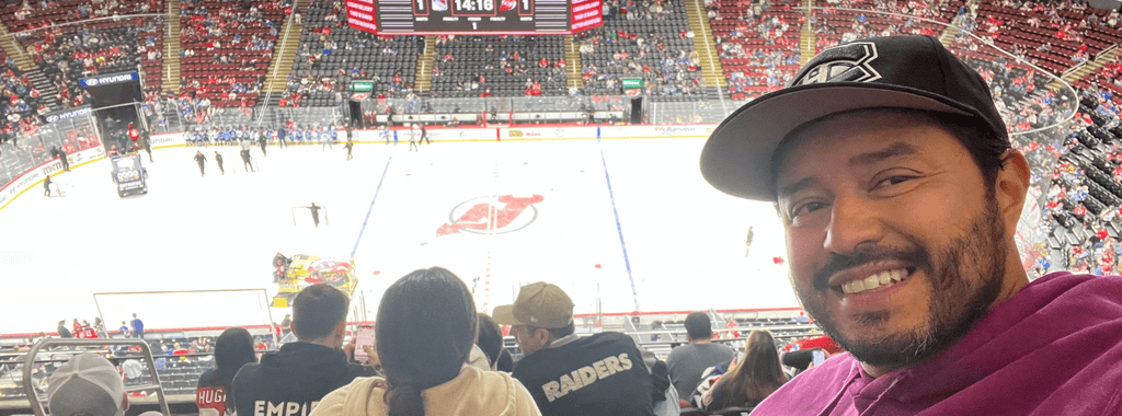 Image of Felipe Caro, illustrator from Inky Thinking watching an ice hockey match in New York