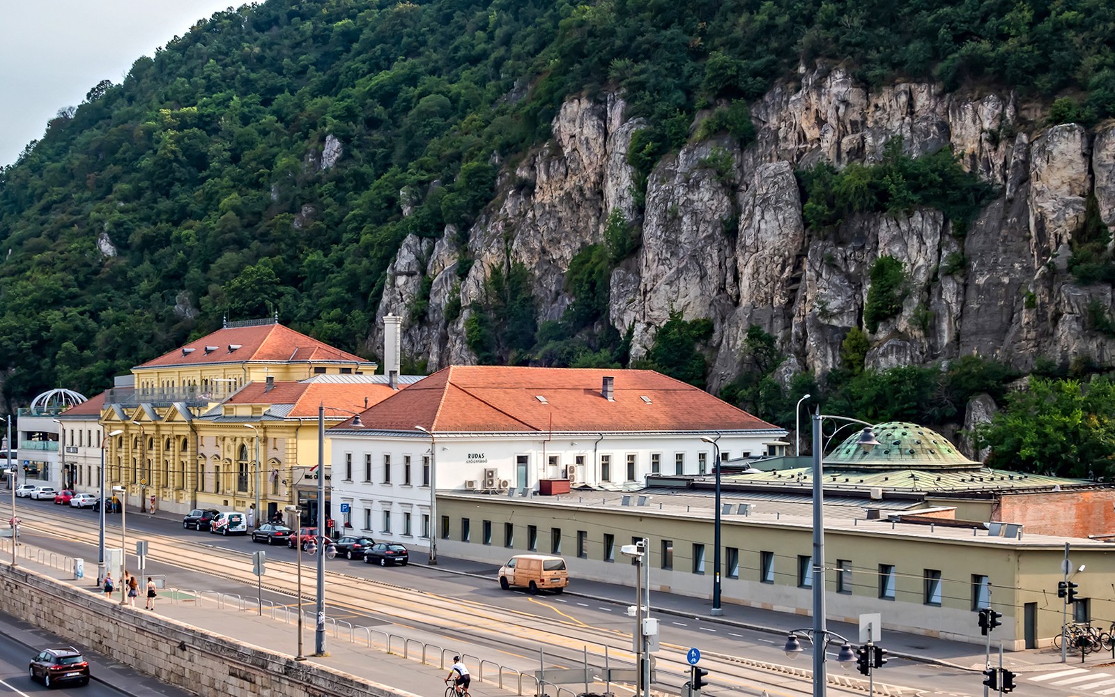 Rudas Thermal Spa building with rocky hillside backdrop in Budapest.