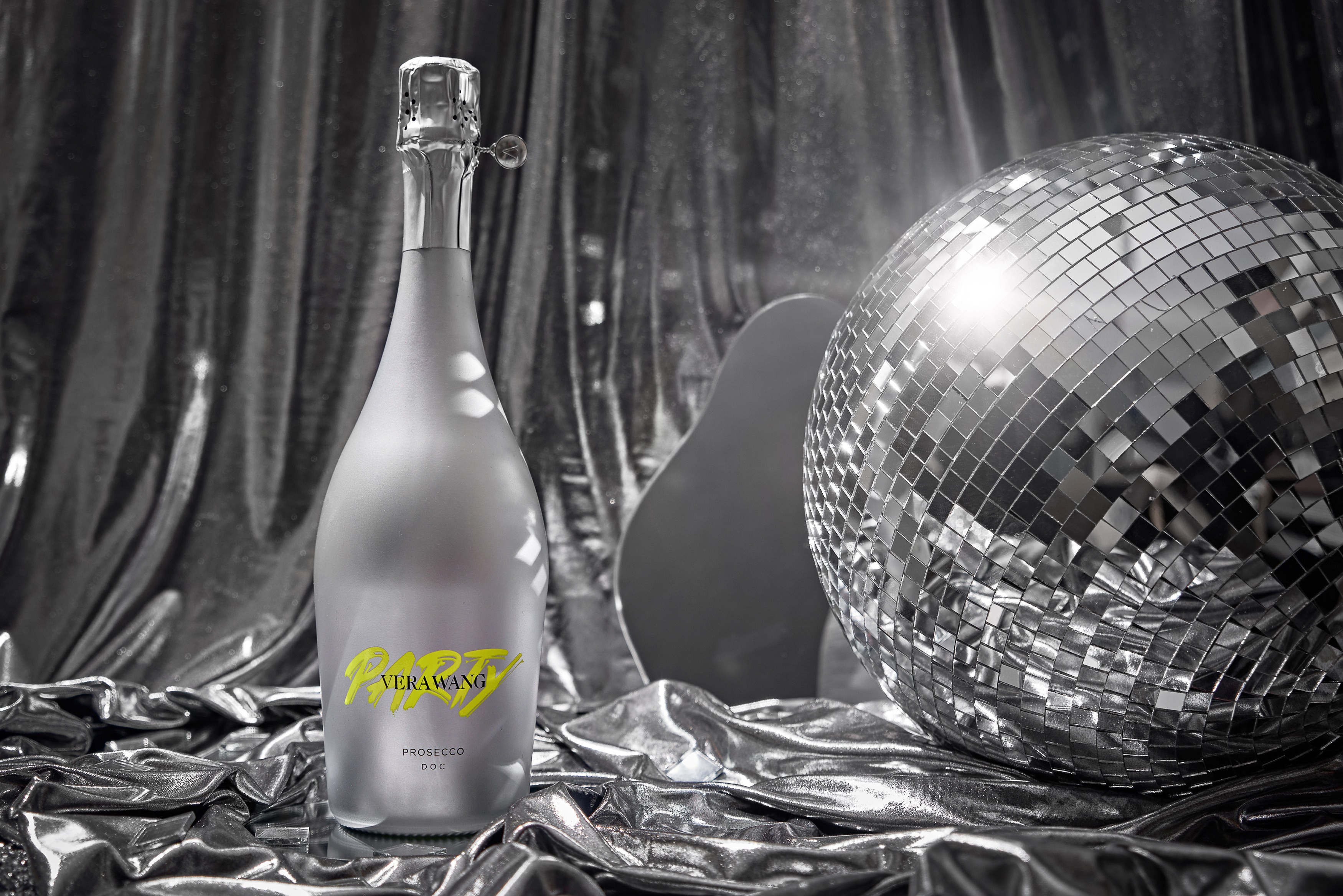 Vera Wang PARTY Prosecco bottle among mirrors and a disco ball