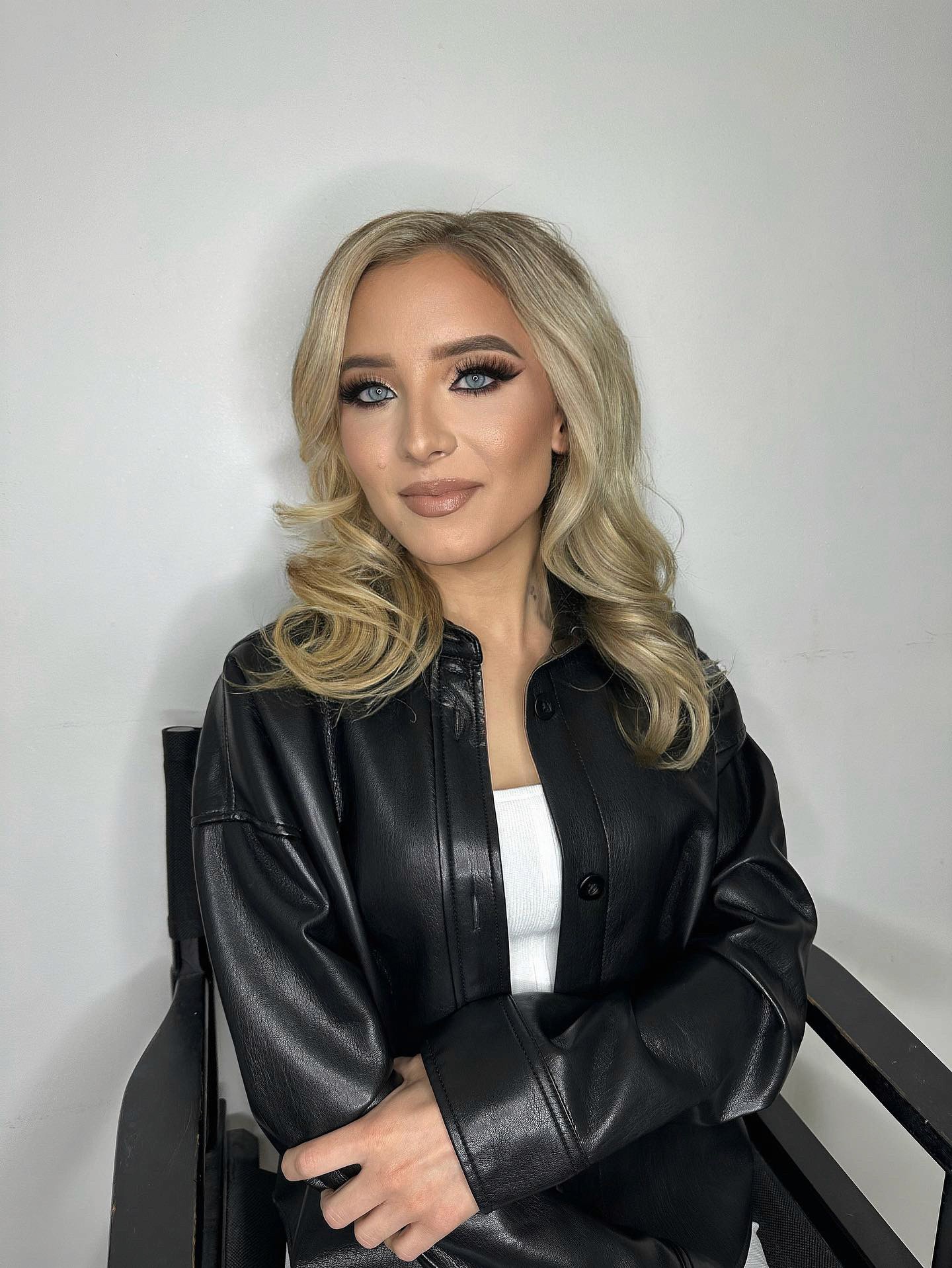 “Gayle Fuller kneeling in meditation with open arms, dressed in white, embodying spiritual surrender, divine connection, and energetic alignment”