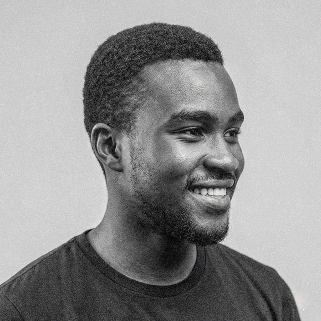 Portrait of a woman with straight long hair, in a dark t-shirt, set against a neutral backdrop.