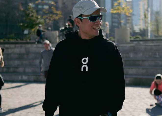 Profile portrait of a man in a white shirt against a light background