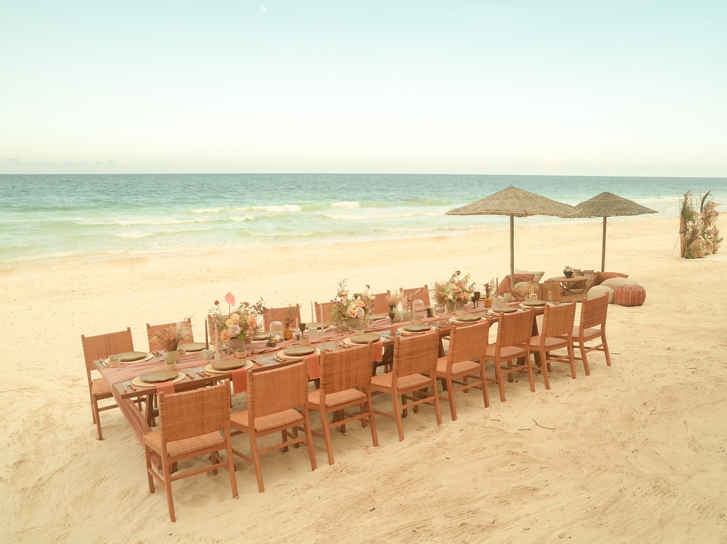 Group of people discussing their spiritual yoga journey on the beach at Nomade Holbox in Tulum Mexico, with a serene and peaceful atmosphere