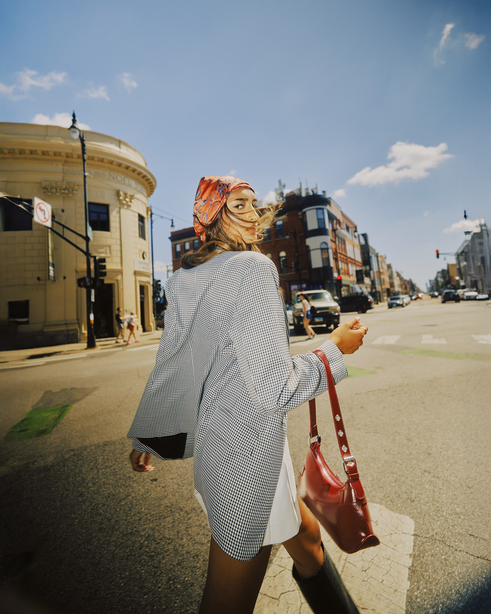 A lone figure stands on a sand dune at sunset.