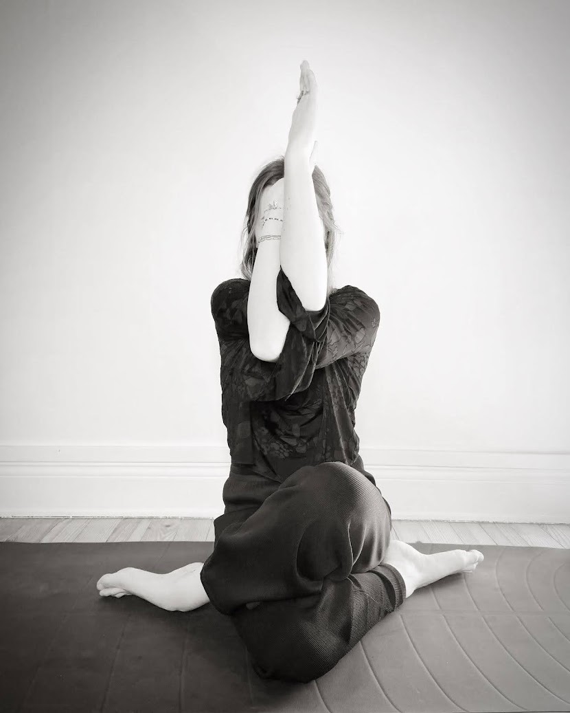 Image de fond de la page d'accueil ou hero section sur Mobile, photo de face, jambes croisées, genoux l'un au dessus de l'autre, talons vers les fesses, rotation externe des hanches et bras croisés mains vers le haut