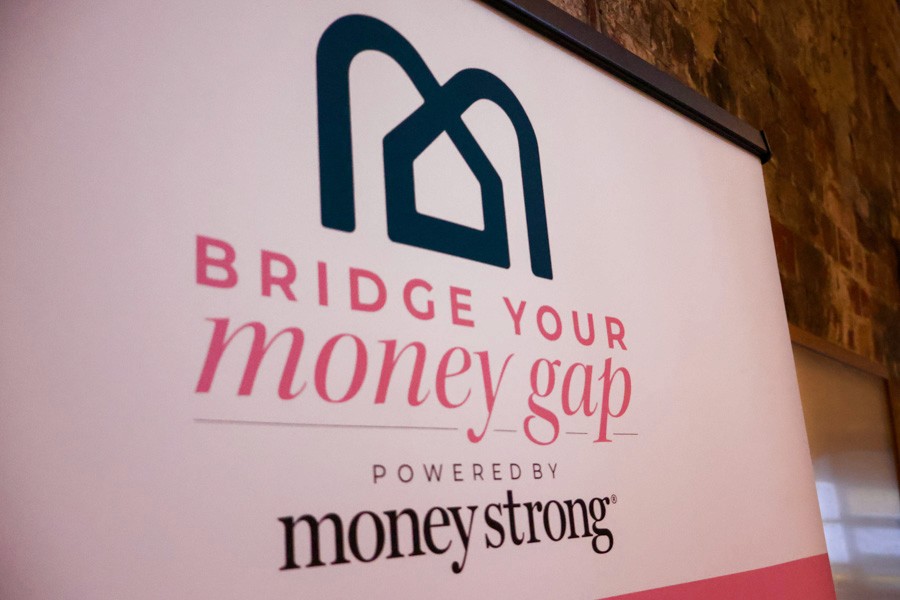 sign that reads "bridge your money gap, powered by money strong"