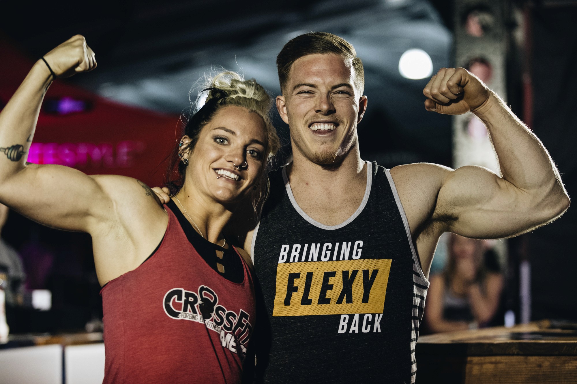 couple flexing - How to Create a Personalized Workout Plan