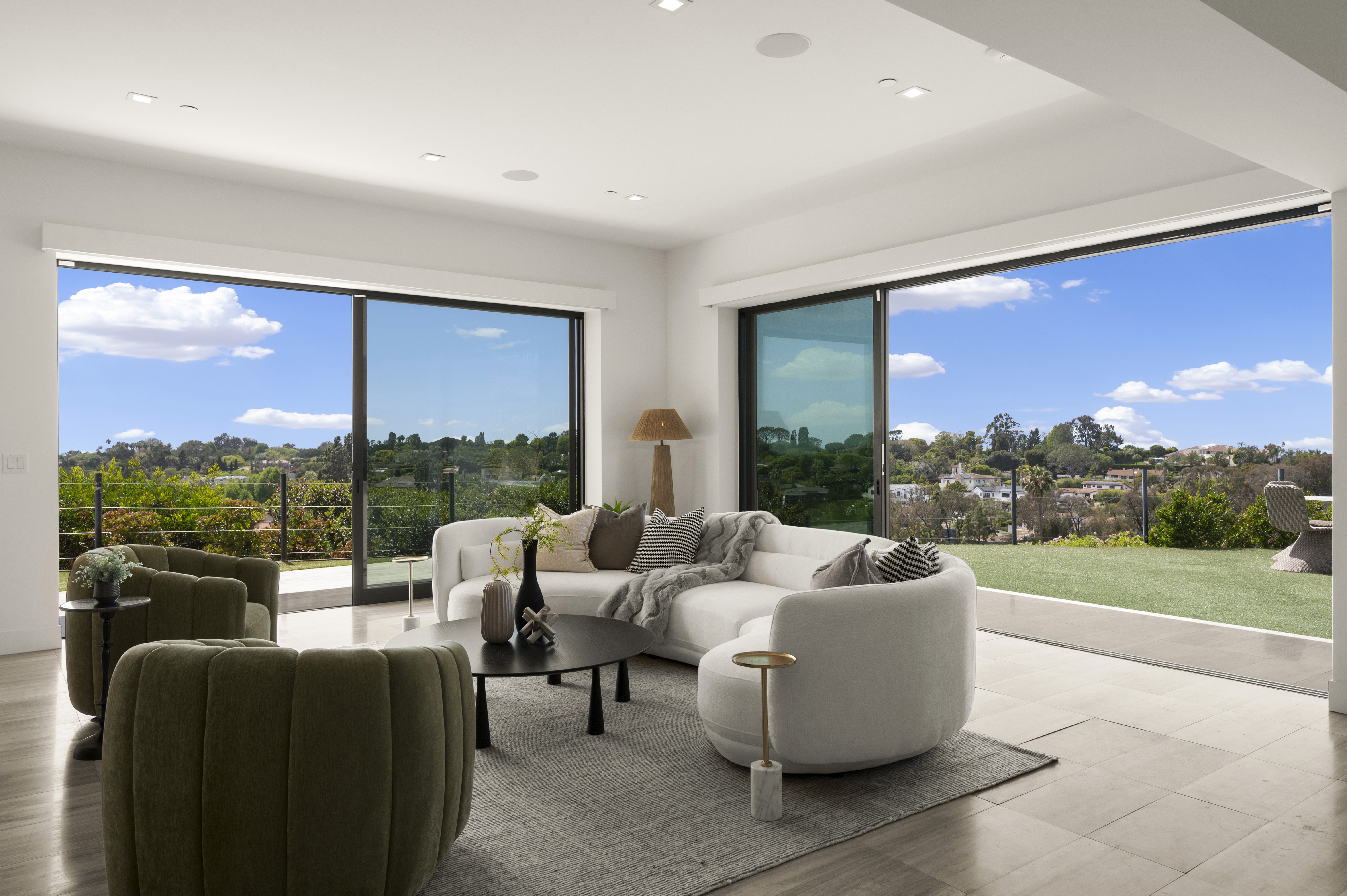 Professionally staged living room with ocean-view windows