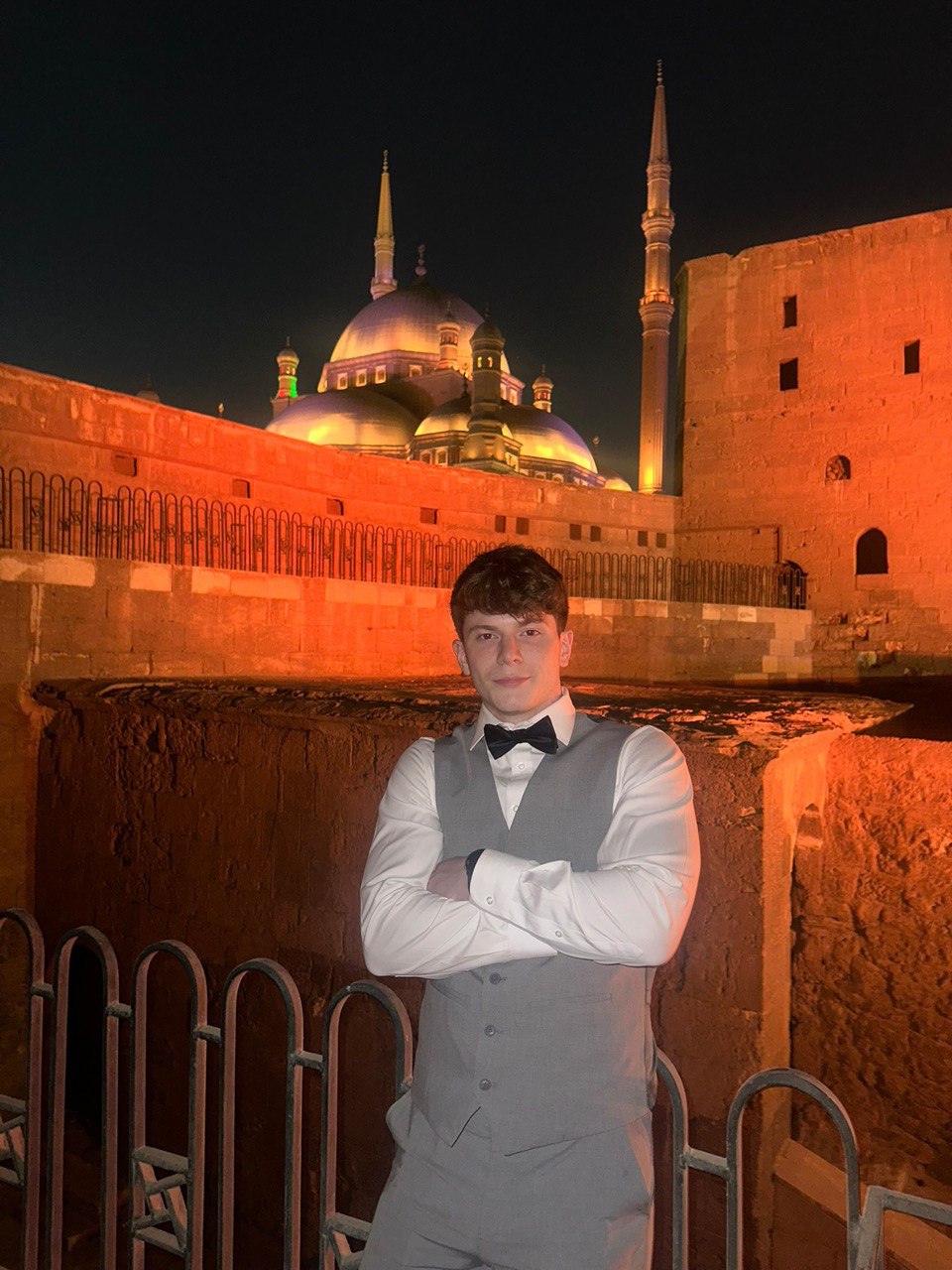 Portrait of a person in dark clothing speaking on a phone