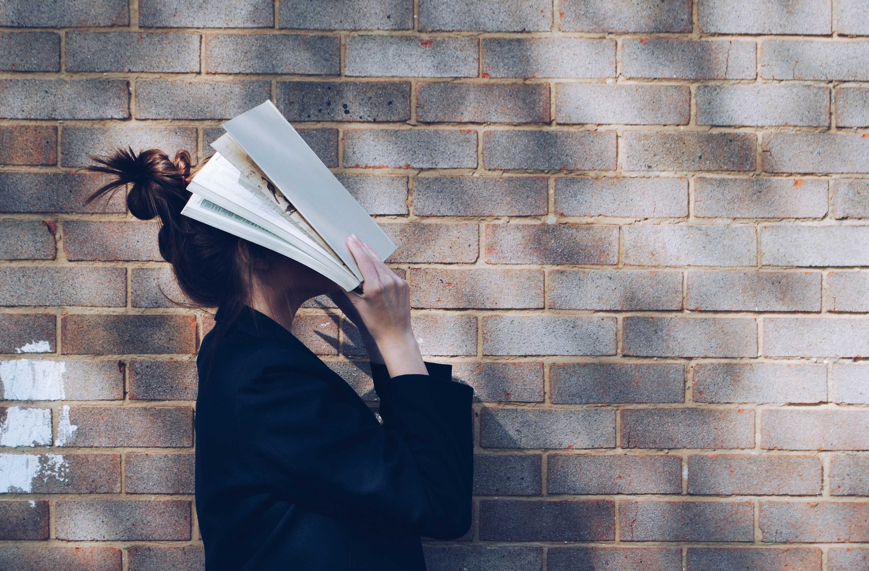 Girl Holding a Book on Her Head - What Is Second Brain Studying