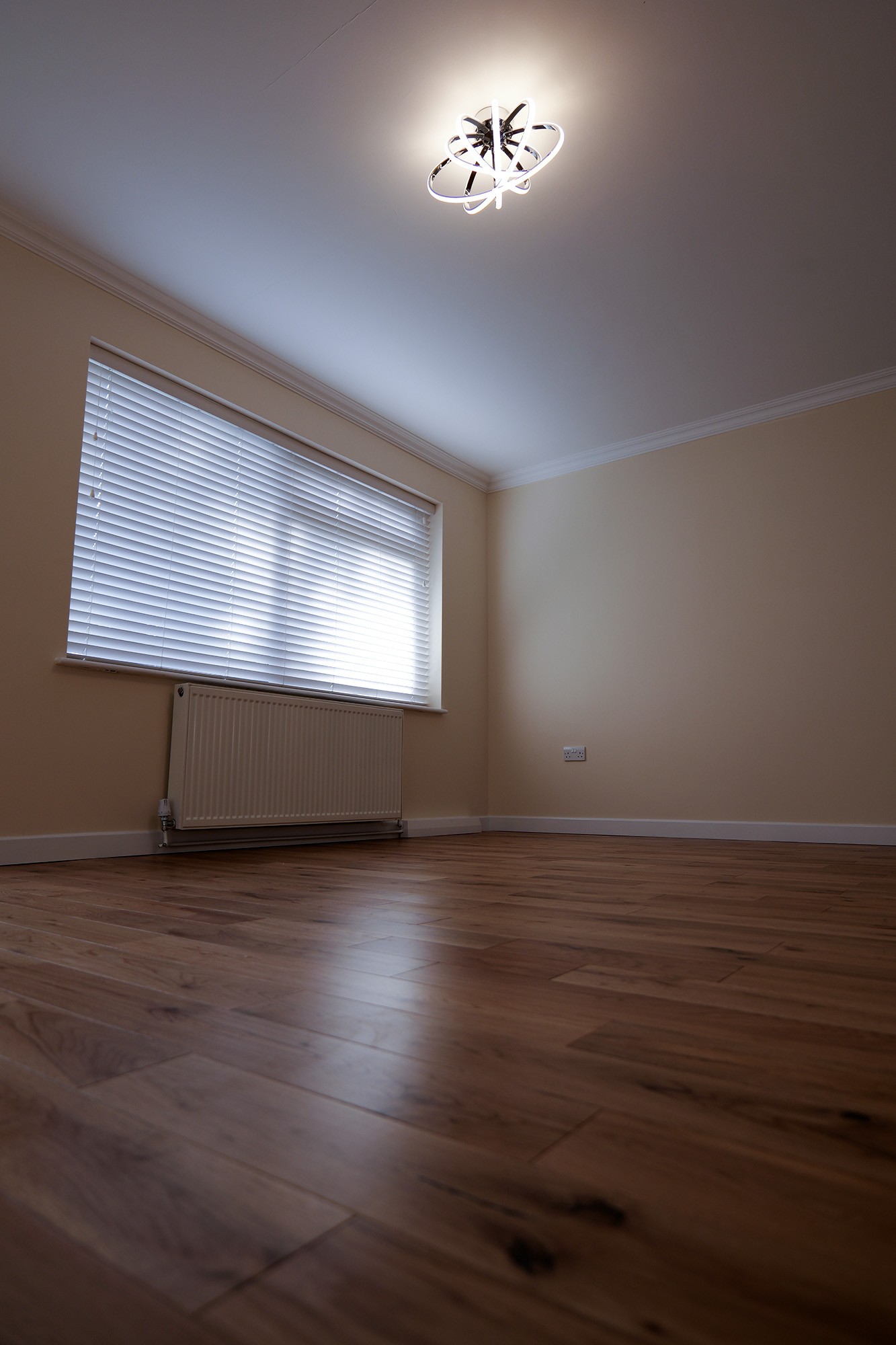 Large living room featuring new wood flooring and lights on ceiling